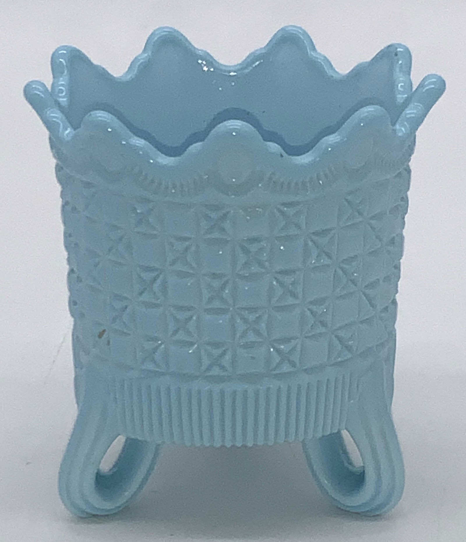 Antique Victorian SOWERBY Blue Milk Glass Vessel: A small glass vessel/ possibly toothpick holder made of Blue Milk Glass by Sowerby with trademark Sowerby Peacock embossed on interior with makers mark. Exterior design is a Victorian style with 3 loo