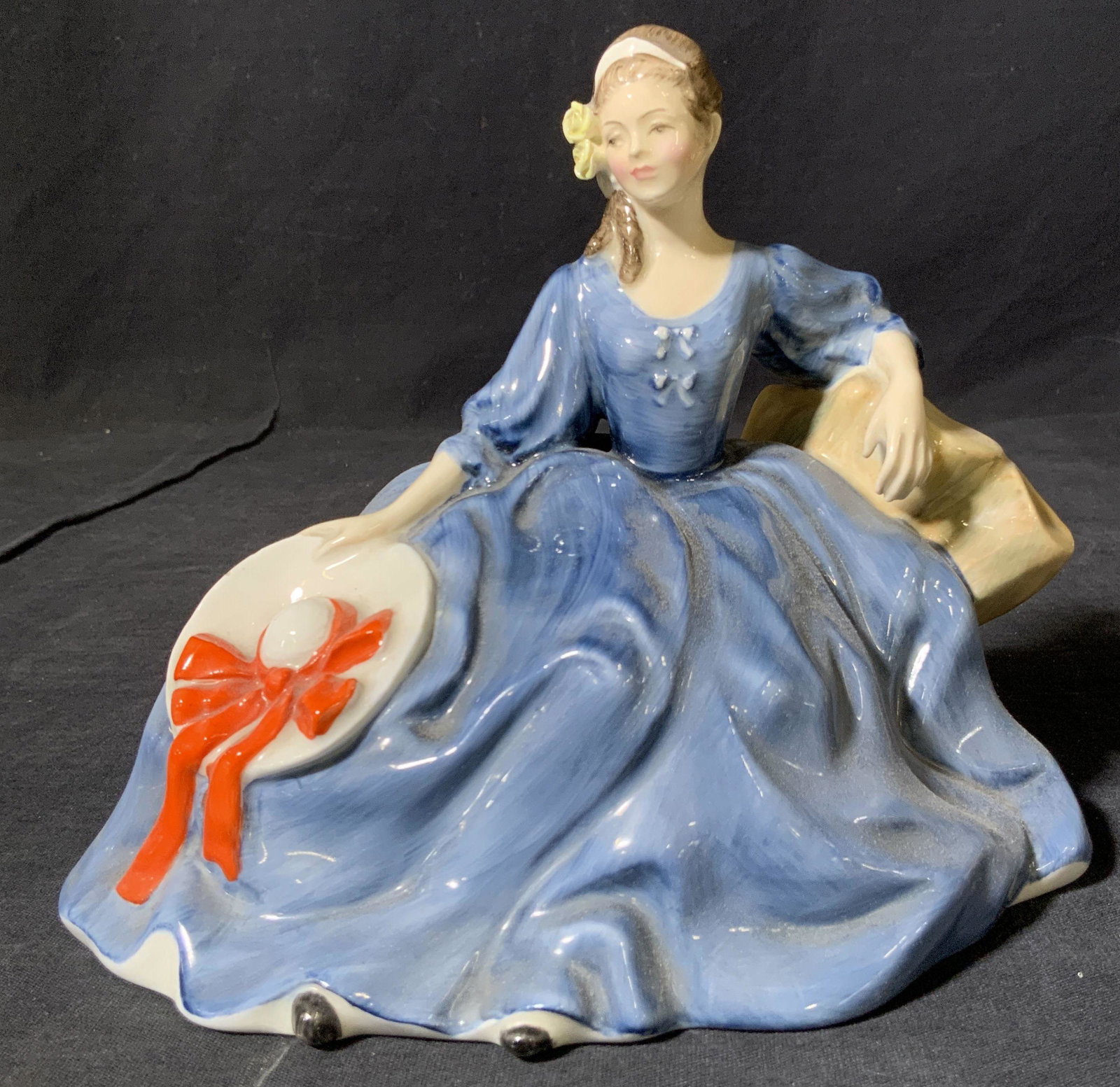 ROYAL DOULTON Porcelain Figural, Elyse: A fine bone porcelain figurine Hallmarked â€˜Royal Doulton Englandâ€™ on underside marked with the name â€˜Elyse H.N 2429â€™ depicting a woman In a blue painted dress reclining on a 