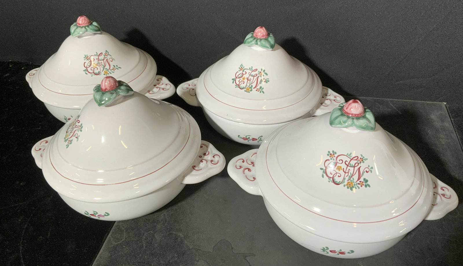 Group Lot 4 French Faience Soup Tureens: Underside of tureens are marked ATELIER DE SEGRIES a MOUSTIERS FRANCE DY 539. Piece is white toned with multi toned floral and leaf detail, lid finial resembles a flower. White glaze over earthenware.