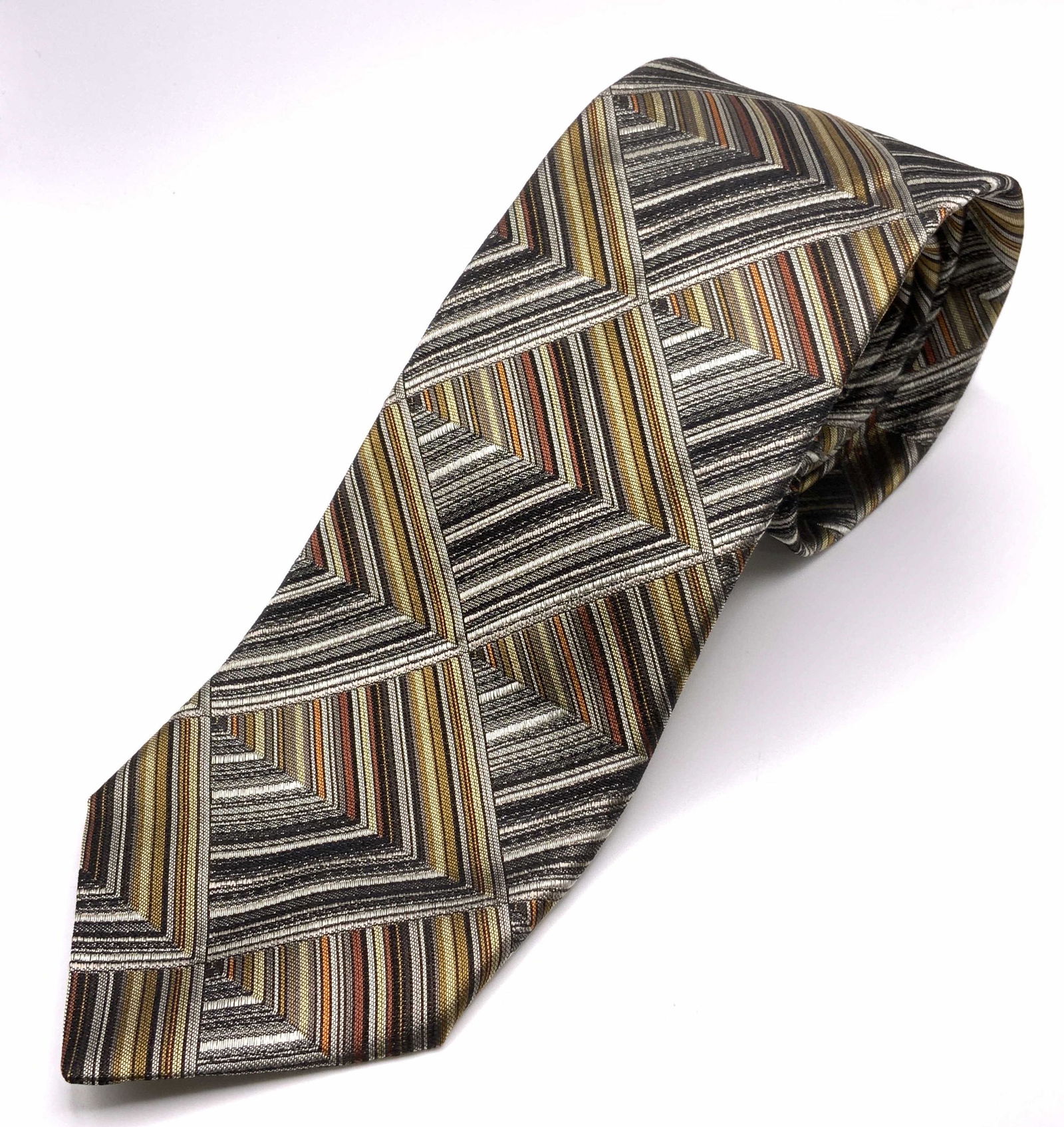 MISSONI Silk Mens Necktie, Italy: Mens necktie. Reads as â€˜MISSONI MADE IN ITALY. 100% seta-soie-Silkâ€™ Decorated with all over print depicting multi toned striations. Wear is consistent with age and use. Measures approx 60