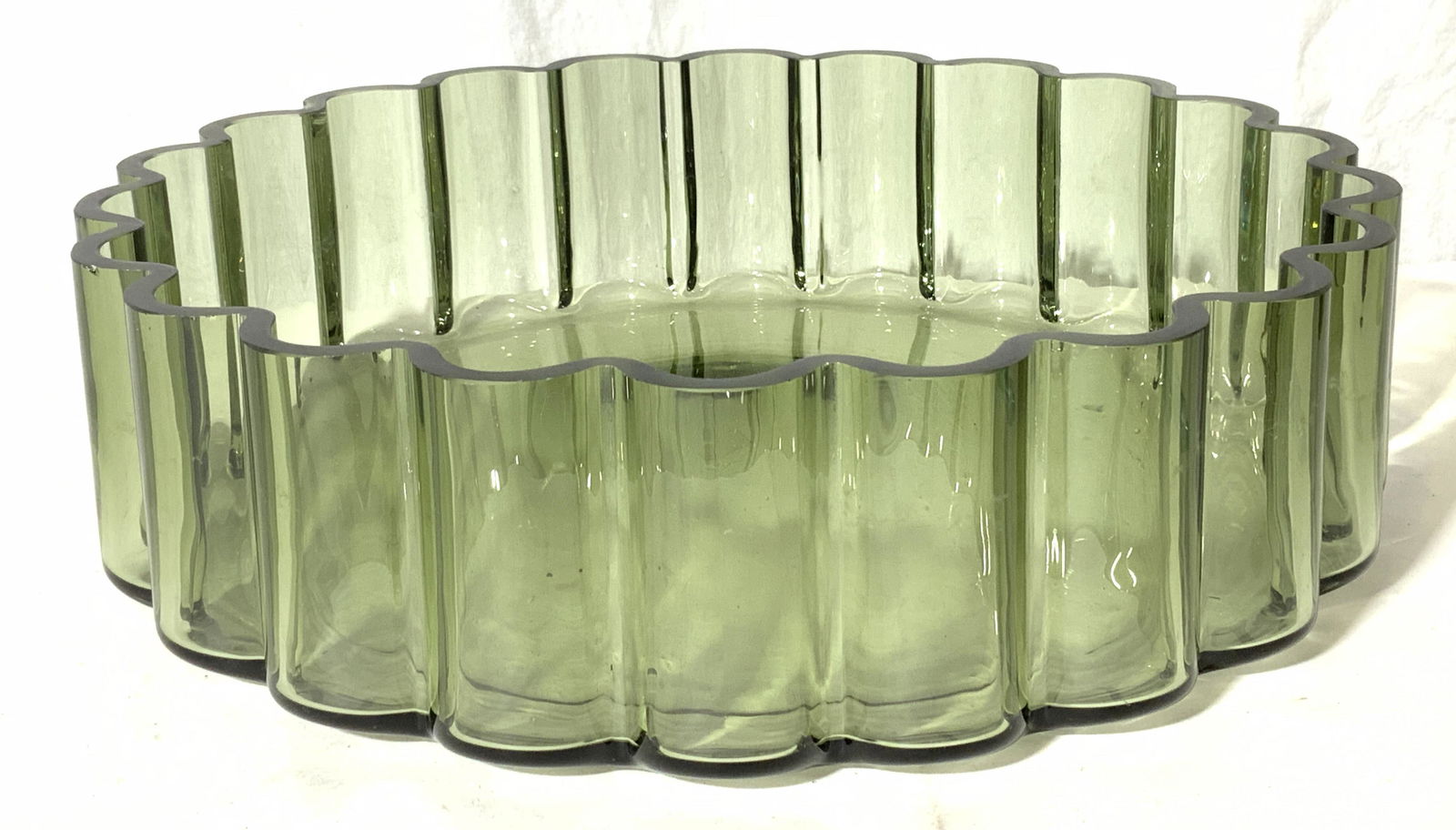 DANSK DESIGNS Centerpiece Glass Bowl: DANSK DESIGNS Centerpiece Glass Bowl, sticker to underside reads â€˜DANSK DESIGNS LTD FINLANDâ€™, subject a translucent green toned glass bowl, measures 11 1/2 x 11 1/2 x 3 1/4 inches, surfac