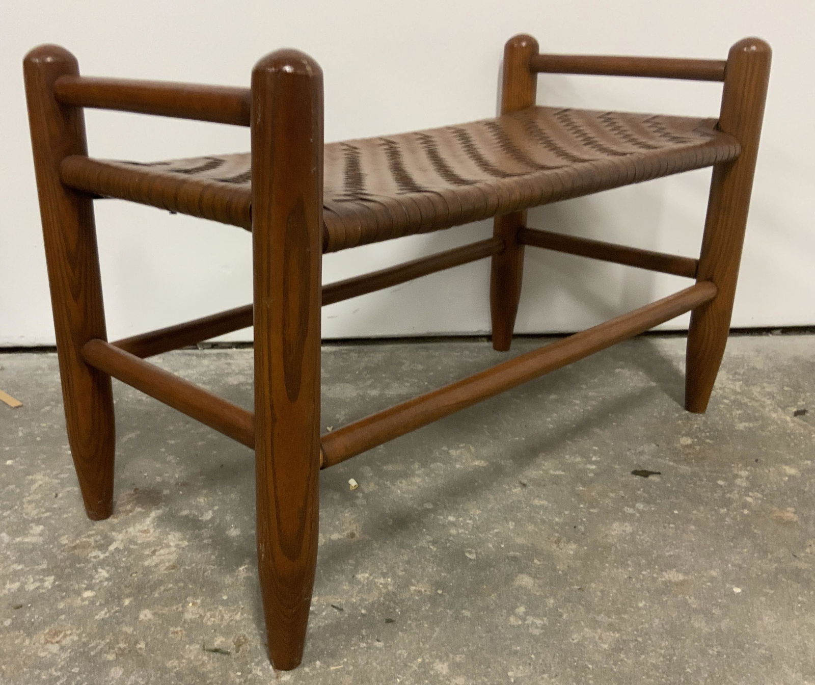 Vintage Mid Century Modern Wooden Shoe Rack: A vintage wooden mid century modern style shoe rack with a woven top. Rounded legs with a taper. Rich brown hue. Some separation at joints. Some discoloration. Measures approx 15H x 24W in. upcycle as