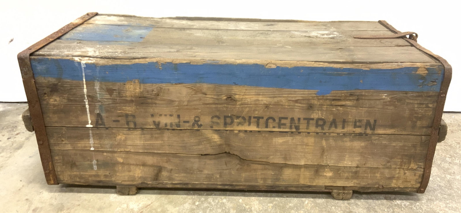 Antique V&S Group Wooden Chest: Antique Wooden trunk, crafted to hold bottles. Joints are secured with cast iron brackets. Hand painted, wear is consistent with age and use, splitting of wood present, rust present. Measures approx 1
