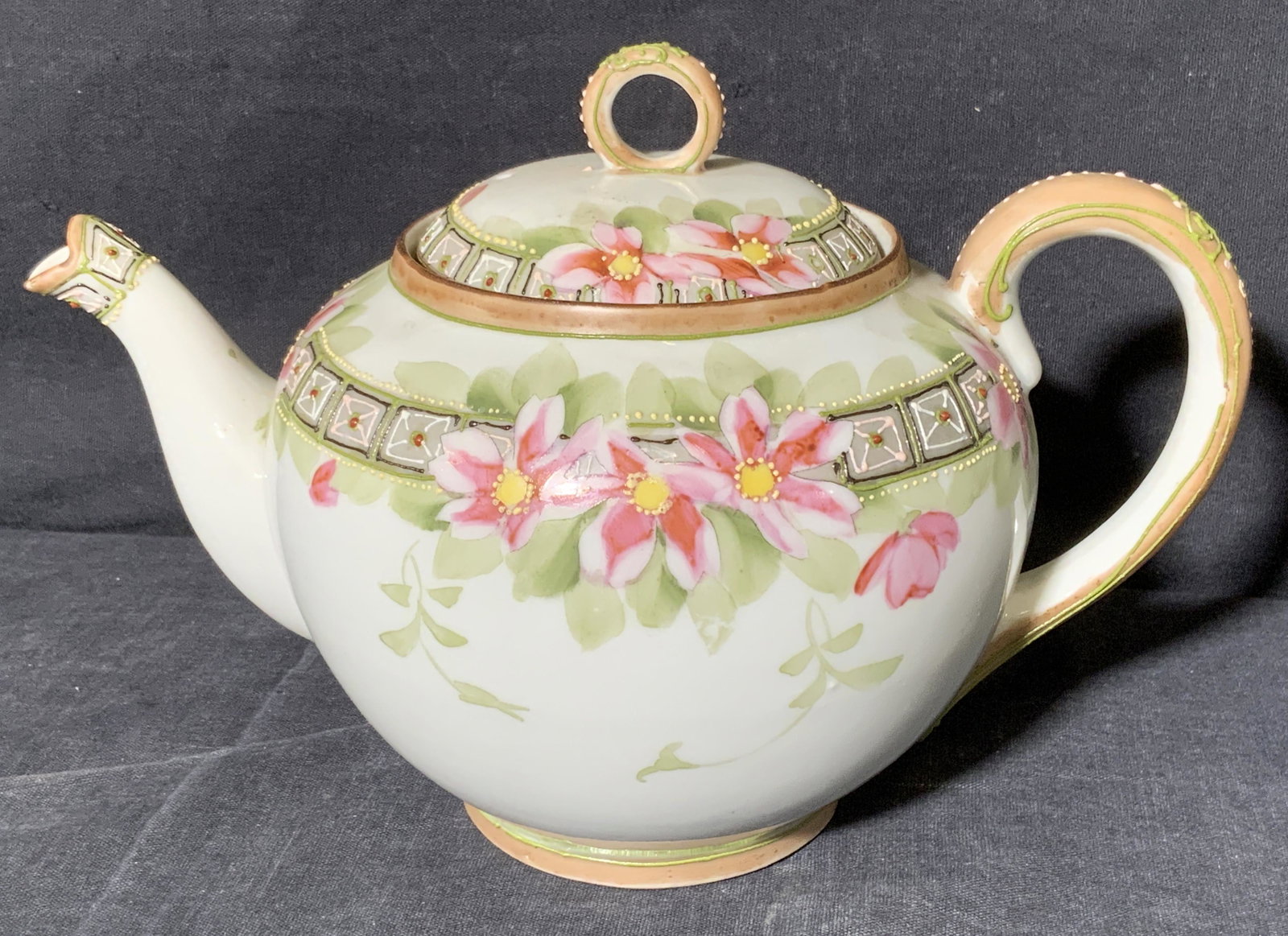 NIPPON Floral Teapot with Raised Detail: NIPPON Floral Teapot with Raised Detail, underside reads â€˜HANDPAINTED NIPPONâ€™, subject a teapot with pink toned floral detail with raised pattern detail, measures 6 x 8 1/2 x 5 1/2 inches