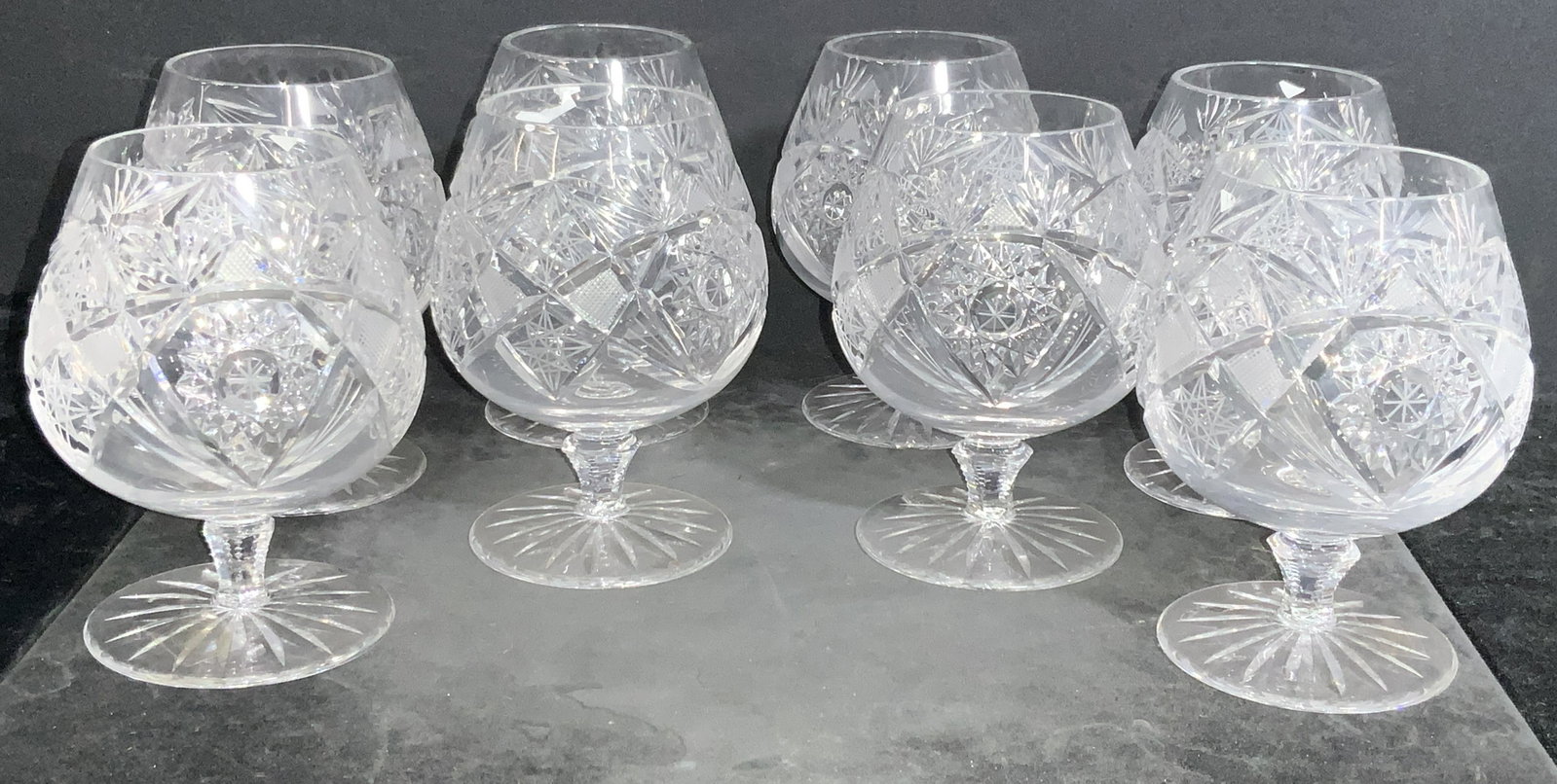 8 PCs AJKA Hungarian Crystal Brandy Snifters: A set of 8 cut crystal stemmed brandy Snifters by the Hungarian Crystal Manufacturers, some marked with Sticker that reads â€˜Ajka, made in Hungaryâ€™ snifters are cut to create multifaceted 