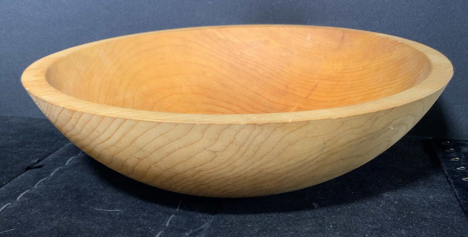 Carved Free Spirit Wooden Bowl: Carved wooden bowl. Underside marked Free Spirit. Wear is consistent with age and use. Measures approx 4 inches h and 14.25 inches w. Salad bowl, mixing bowl, carved wood bowl, home decor, kitchenalia