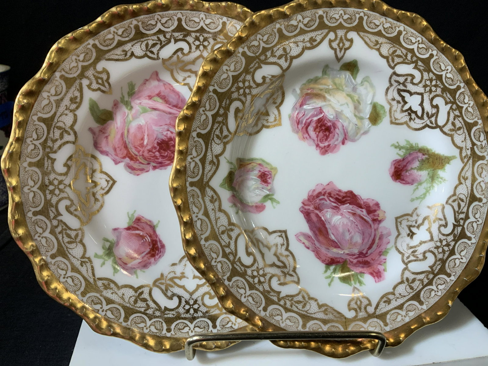 Pair J.P. Limoges France Gilt+Rose Dessert Plates: Vintage Limoges France , stamped under glaze J.P. L France. Intricate detailed gilt work on white porcelain with roses. Plates measure 6.5 in. Wear to paint and gilt, scratches and some chipping obser