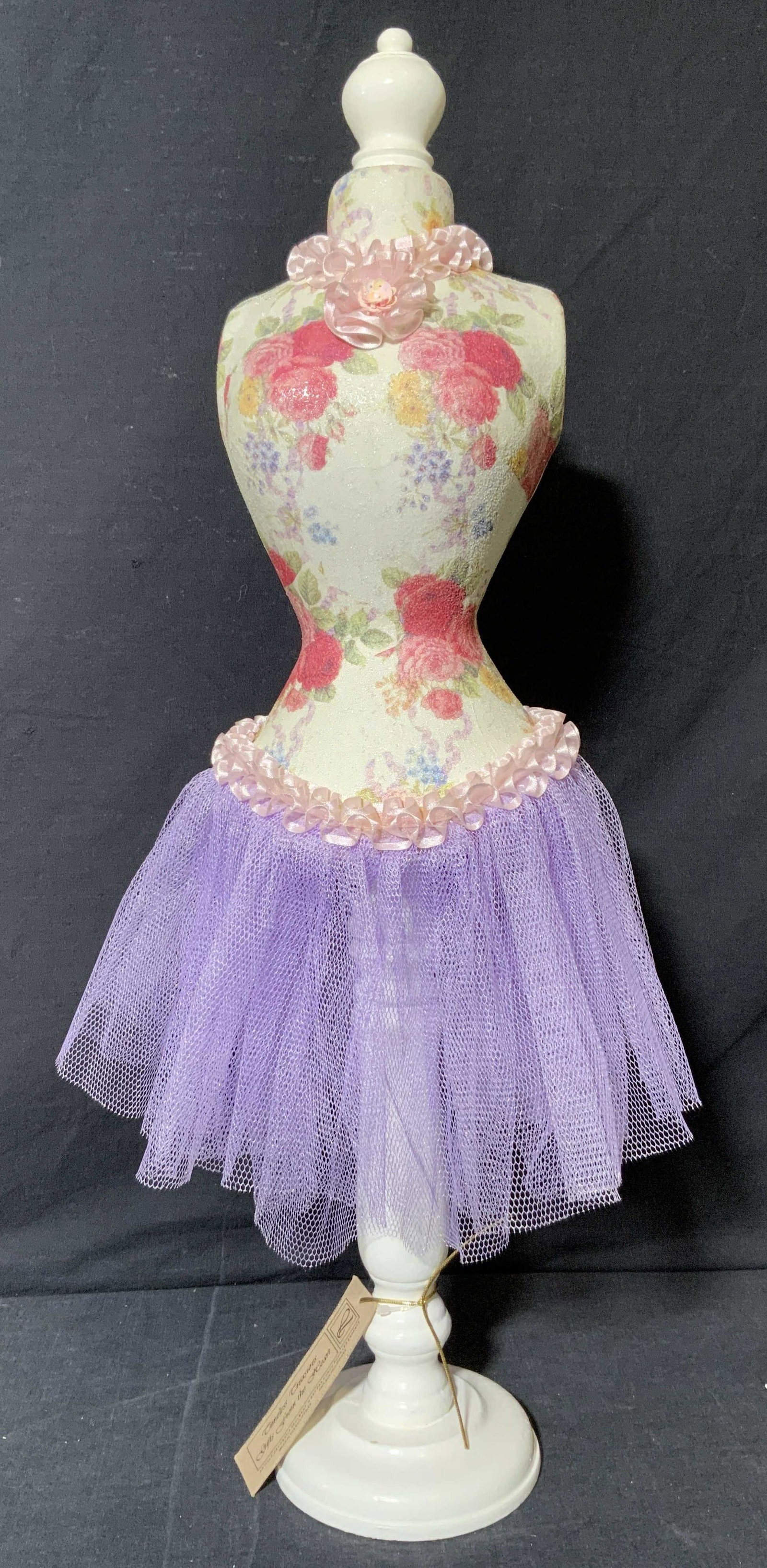 Timeless Treasures Gifts From the Heart Mannequin: Timeless Treasures Gifts From the Heart Mannequin, attached tag reads â€˜Timeless Treasures Gifts From the Heartâ€™, subject a floral mannequin with purple toned skirt and wooden stand, measu