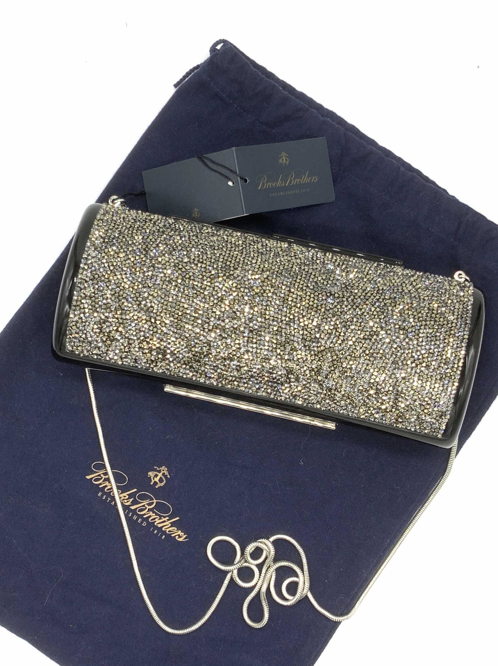 BROOKS BROTHERS NWT Bejeweled Methacrylate Purse: A black Methacrylate cylindrical shoulder purse / clutch bejeweled with faceted marcasite and colorless crystals. Silver tone tube chain strap. Chain can be tucked into purse. Snap closure. Interior l
