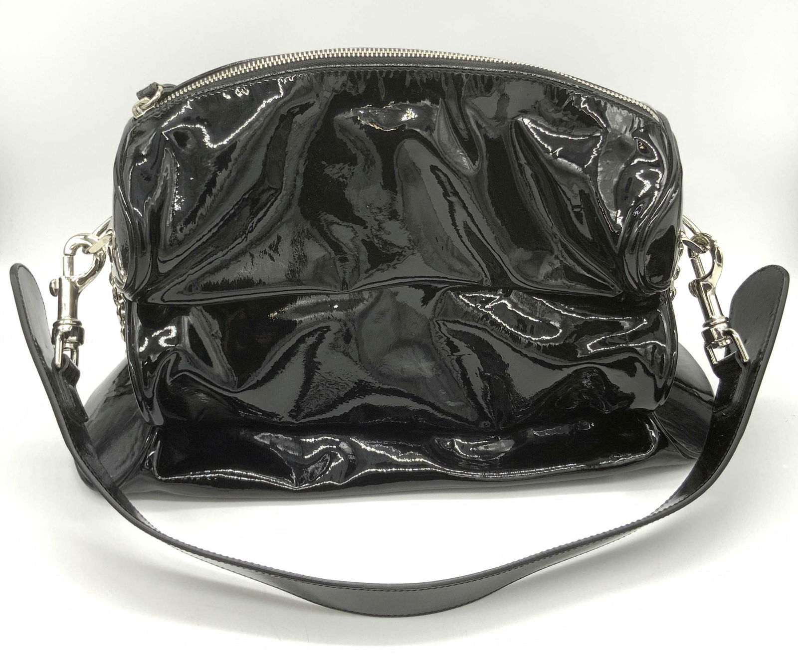 ESCADA Italian Patent Black Leather Ladies Purse: A black patent leather purse with silver tone metal hardware. Top handle. Zipper closure. Lined interior. Interior reads Escada, Made in Italy. Underside possesses silver tone metal feet. Purse measur