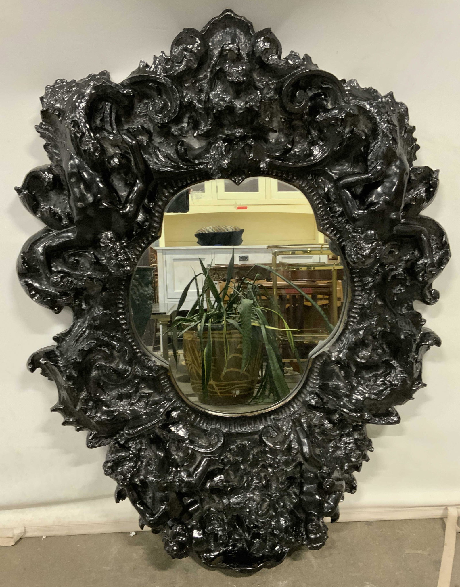 FINESSE ORIGINALS Signed Adam & Eve Comp Mirror: Top of mirror is signed FINESSE ORIGINALS. Mirror has black toned composite frame. Piece has male & female nude figures (Adam & Eve) & ornate c and s scroll detail. Piece measures approx 47 inches tal