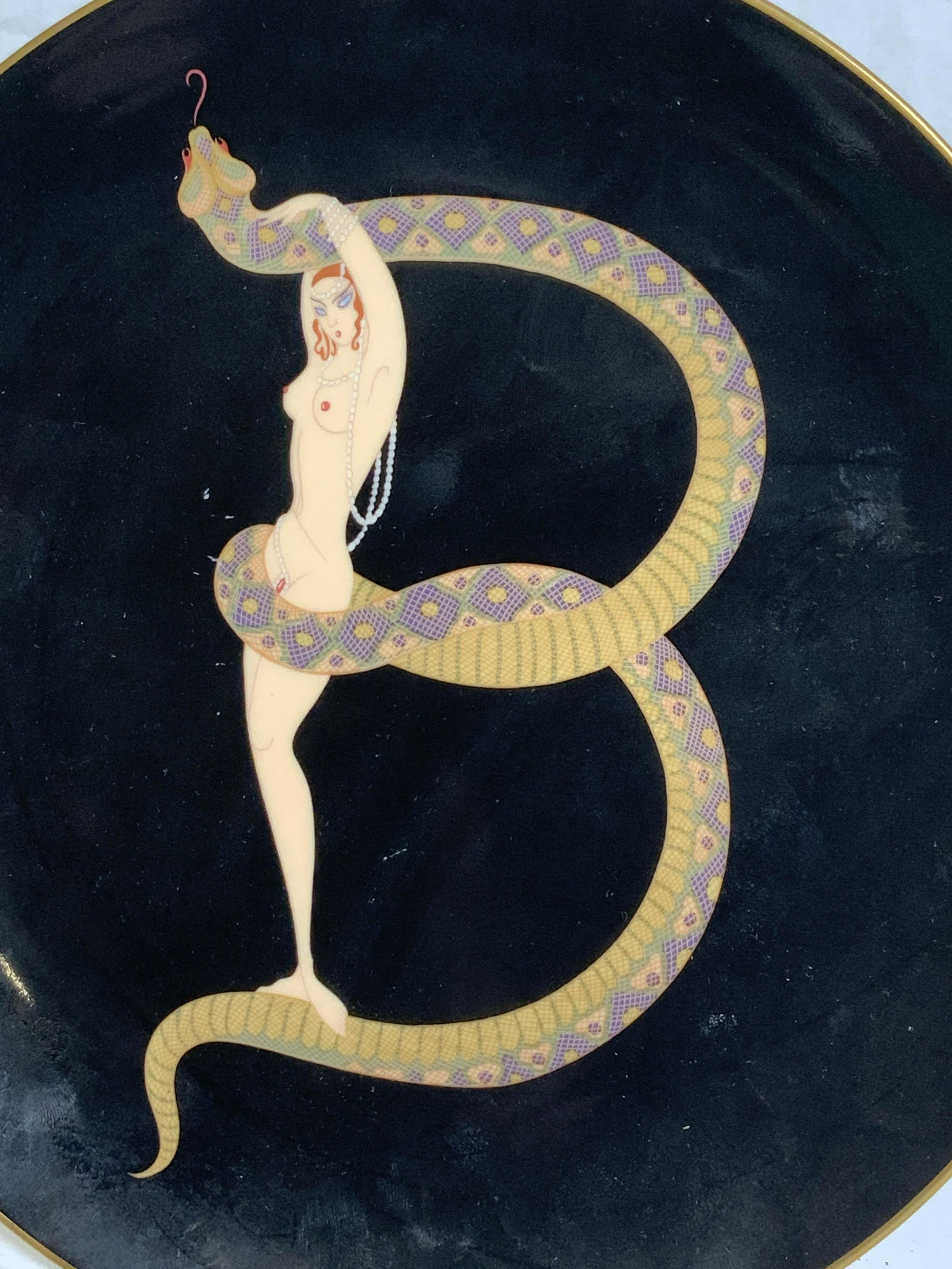ERTE Nude Deco China Plate, THE ALPHABET B: ERTEs The Alphabet B, c 1986 Nude Art Deco fine bone China plate, 9 Inch diameter, Backside signed and reads The Alphabet B A3204. Depicts nude female with dangling pearls and she is wrap by a snake, 