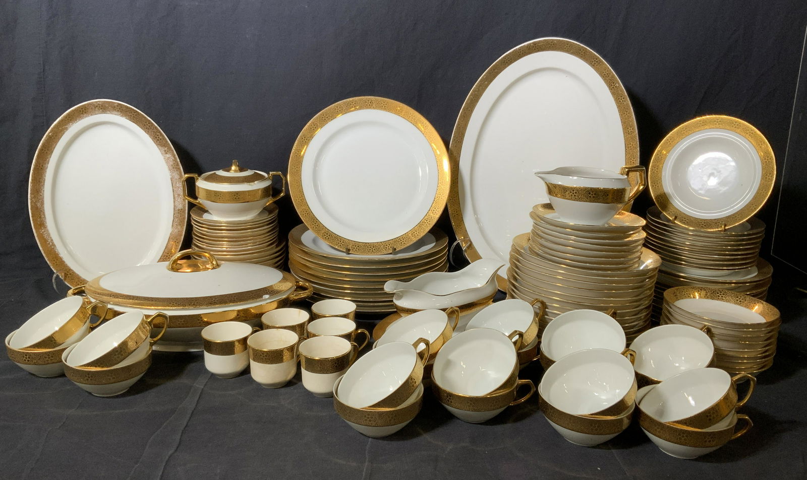 Group Lot ROYAL LB Porcelain Serving Set, Germany: Group lot 103 pc ROYAL LB PORCELAIN. serving set. Includes plates, saucer, gravy boat, tureen w lid, trays, creamer, sugar bowl w lid, tea cups, espresso cups. All colored with gilt paint, swirling pa