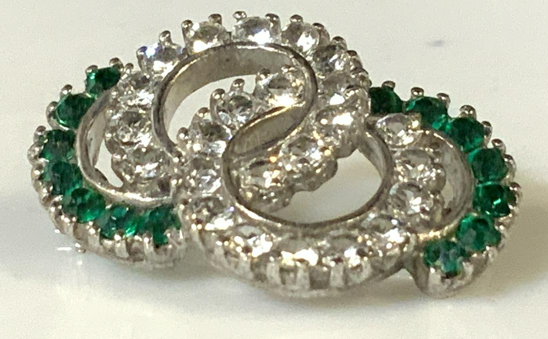 Sterling silver Vtg Emerald and Clear Crystal Pin: Sparking crystal pin with prong set stone, looped circles and semi circle design with clear and green crystals. Hallmarked Sterling on verso. 1 in. Property of Greenwich, CT Estate Sterling Silver bro