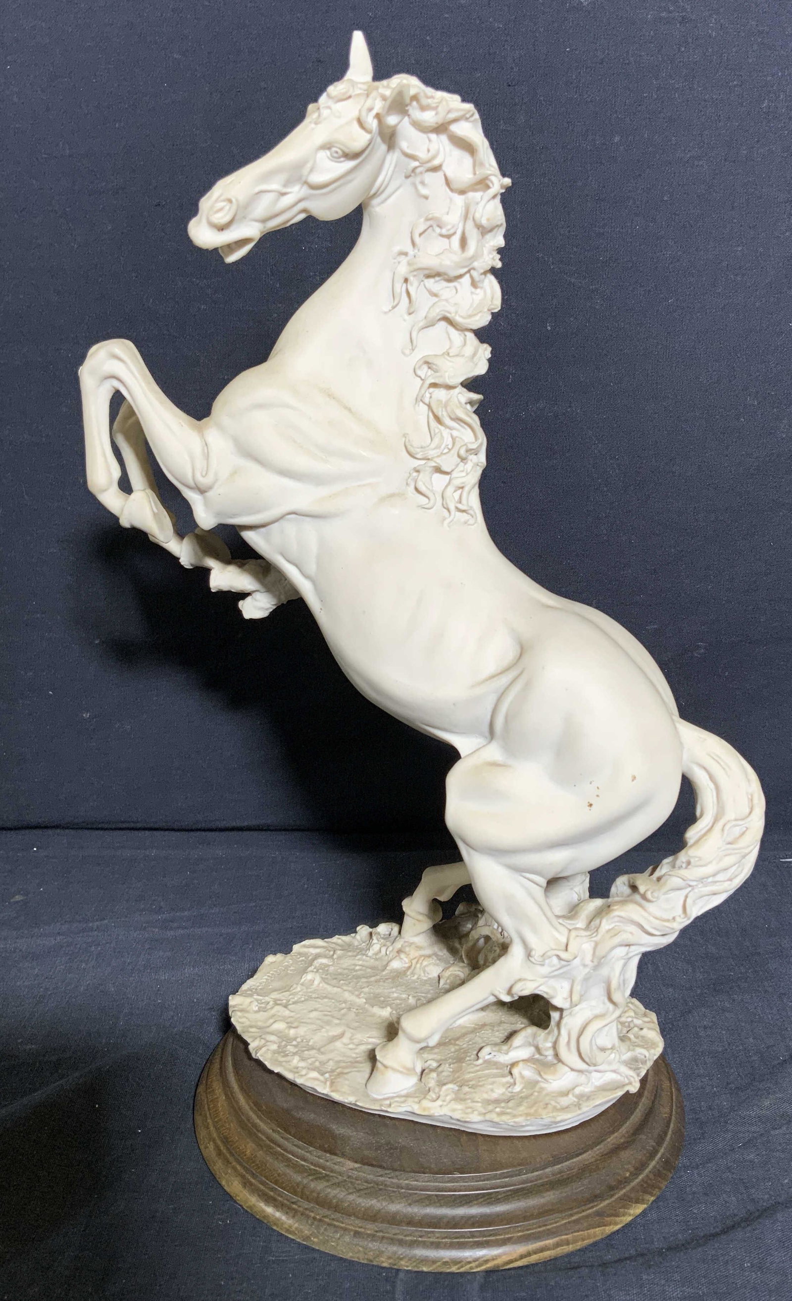 Signed CAPODIMONTE Style Sculpture, Rearing Horse: Signed CAPODIMONTE style Sculpture of a Rearing Horse, signature illegible, measures 8 1/4 x 6 1/4 x 13 inches, minor surface wear. label on underside appears to be Italian translating to - the artist