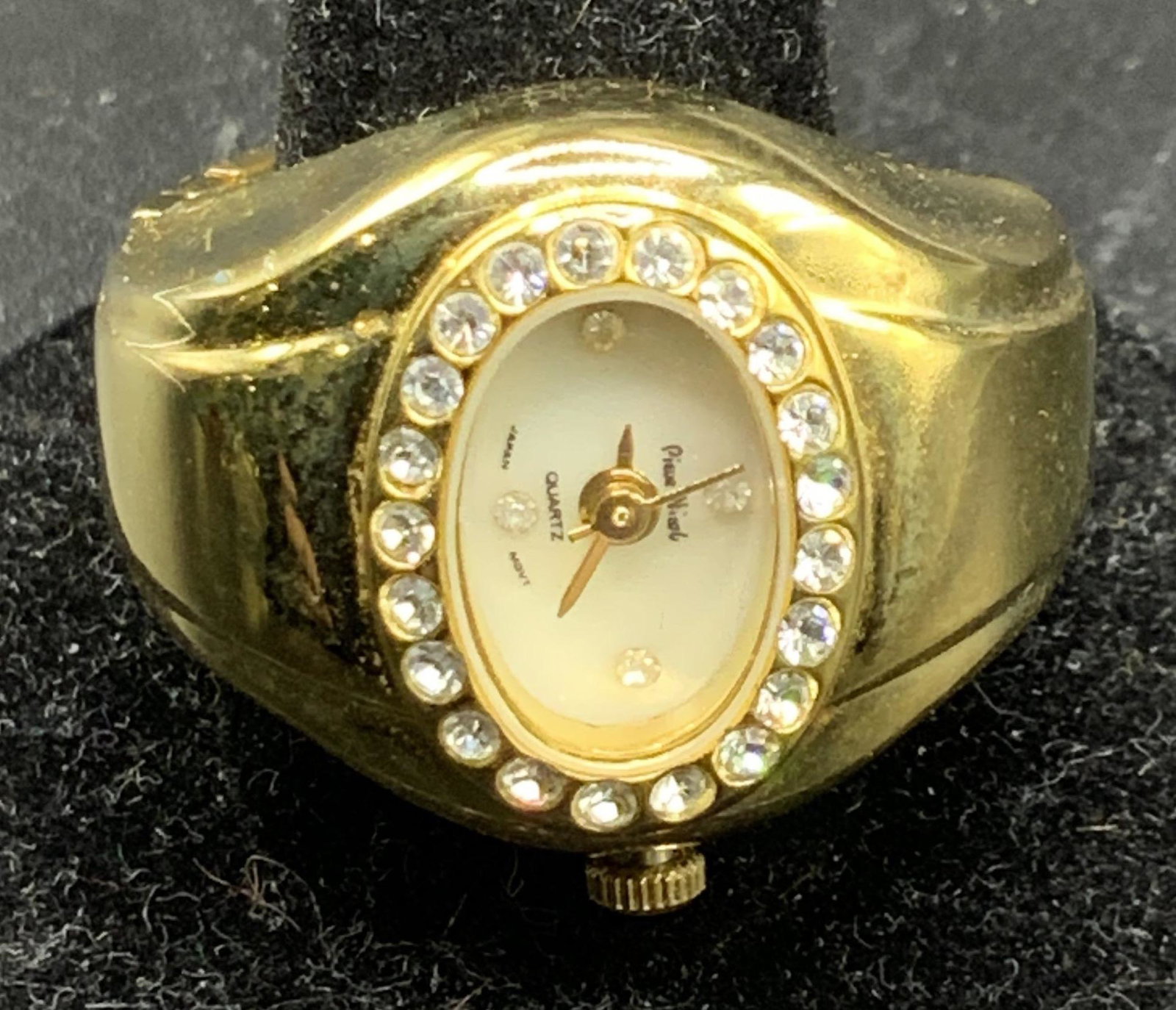 PIEUE NICOLE Stretch Watch Ring: Set in gold tone polished metal with crystal halo, a signed Pieue Nicole Japan Movement Rotary clock stretch ring. Wind up , fits ring size 7-10 Property of Trump Tower Manhattan NY & Bedford Estates.