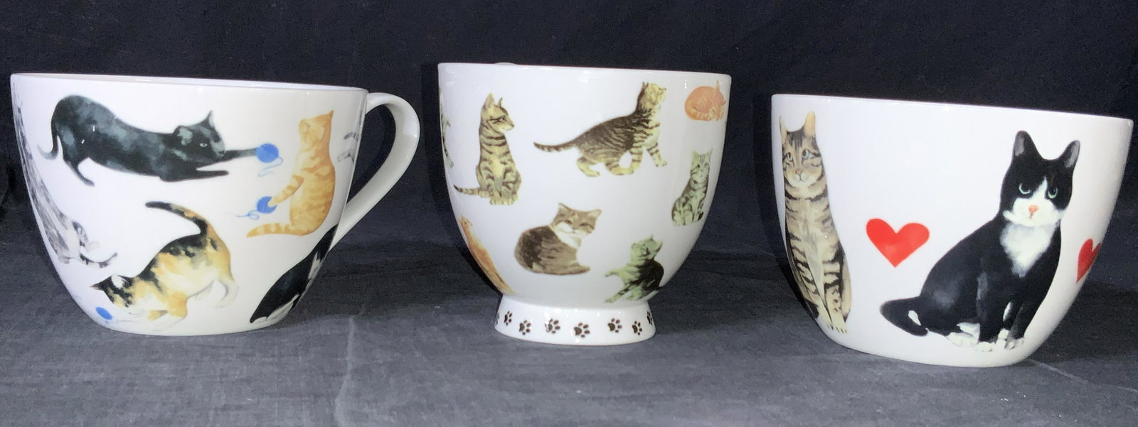 4 PCs PORTOBELLO By Design Porcelain Cat Mugs: A group lot of 4 Porcelain mugs, all marked on underside Portobello by design, bone China designed in England all cups have handles, and 1 has a raised stand. All cups are adorn with realistic cat fig
