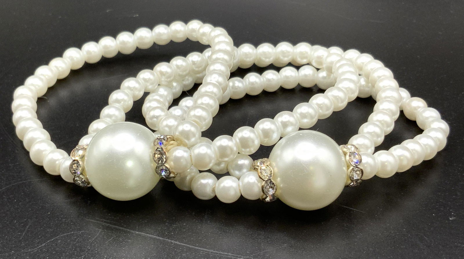 Pair Pearlescent Stretch Bracelets: Two pearlescent beaded bracelets with crystal accents adjacent to larger center pearlescent beads. Stretch bracelets. Approx. Diameter 2 in. Property of Trump Tower Manhattan and Bedford, NY Estates.