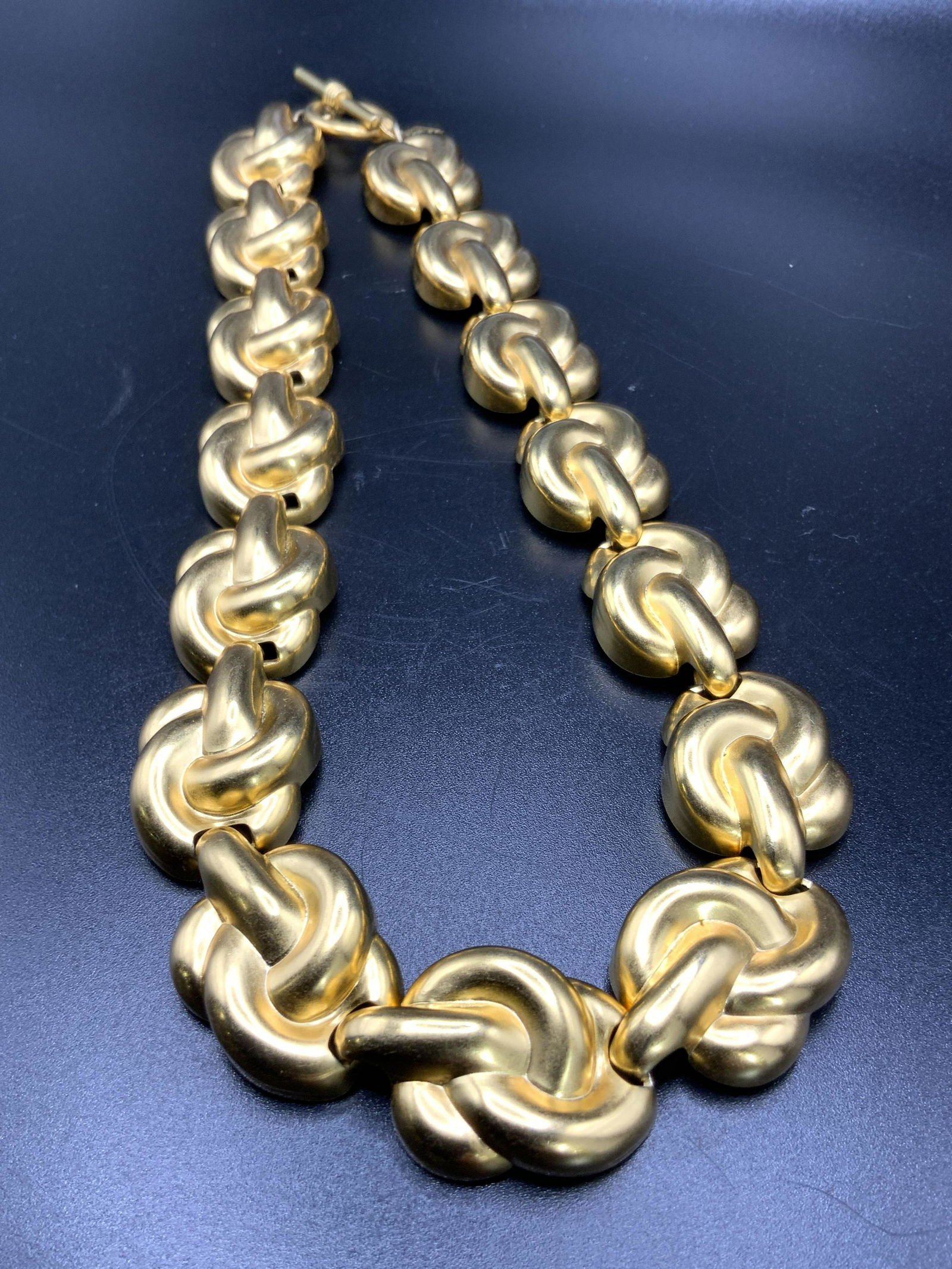 ANNE KLEIN Chunky Gold Tone Metal Choker Necklace: A chunky gold tone metal love knot style choker necklace. Toggle closure. Charm adjacent to closure reads Anne Klein. Measures approx 18 inches in length. Collectible jewelry, chunky Jewelry, Fashion