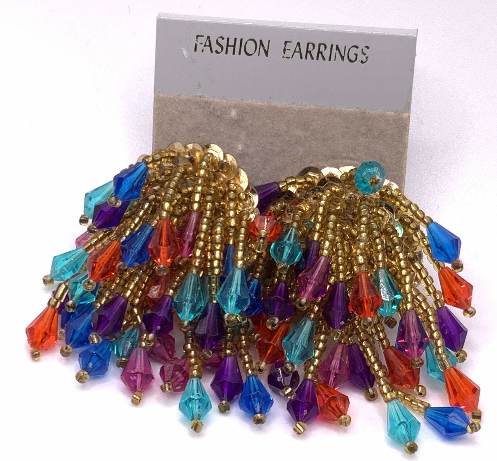 Vintage Beaded Cluster Clip On Earrings, Org Pck: A pair of beaded cluster earrings with gold tone metal clip on backings. Beads are a variety of colors. Faceted beads and seed beads. Earrings measure approx 2L x 1W in. Pieces are connected to their