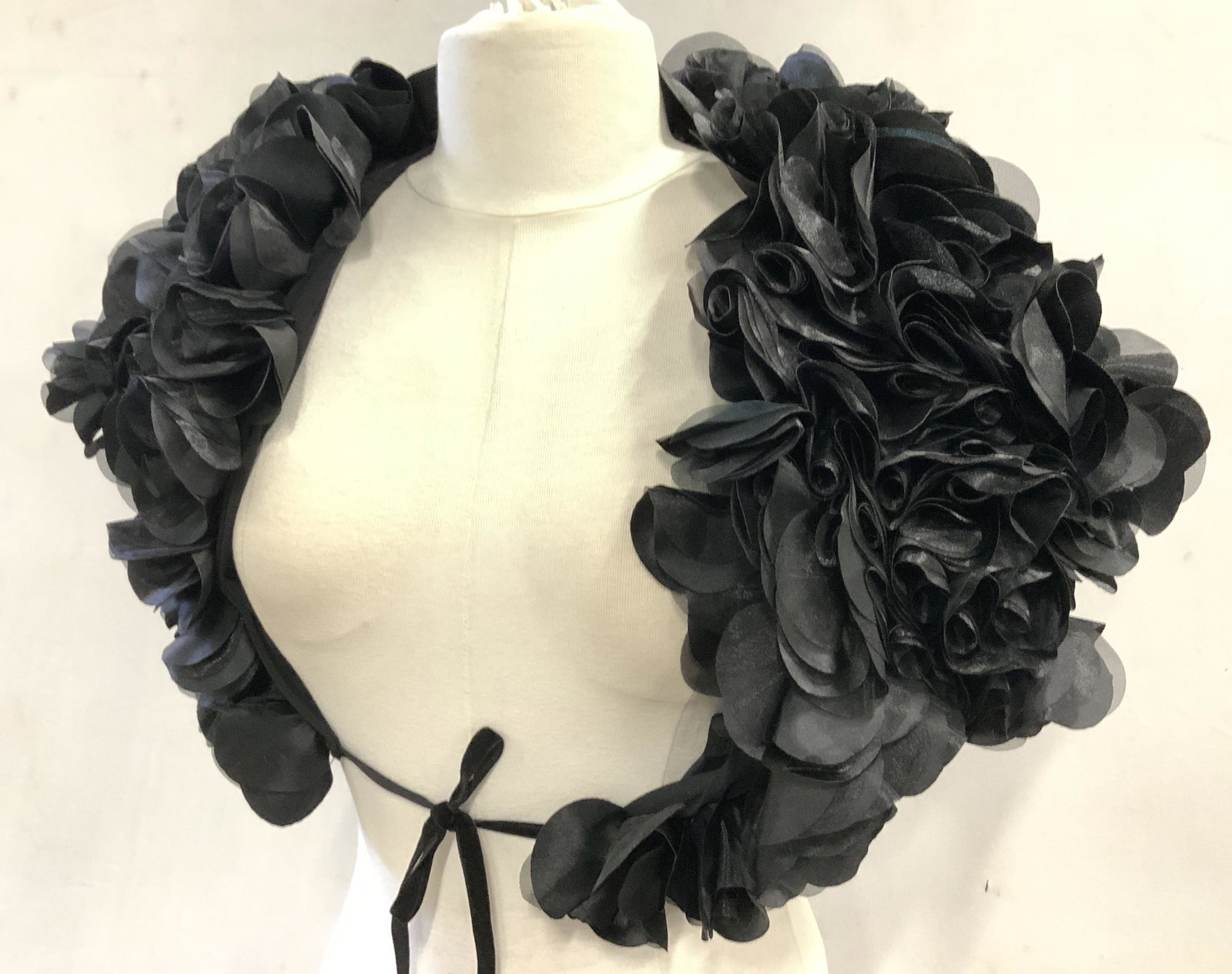 Dressy Black Rosette Fancy Stole/Bolero: Ladies size Medium short sleeve stole/ crop bolero made of polyester. Straps on bottom to tie around body, full of black rosettes, fully lined , measures 12 in. x 23 in. Ladies evening wear accessory,