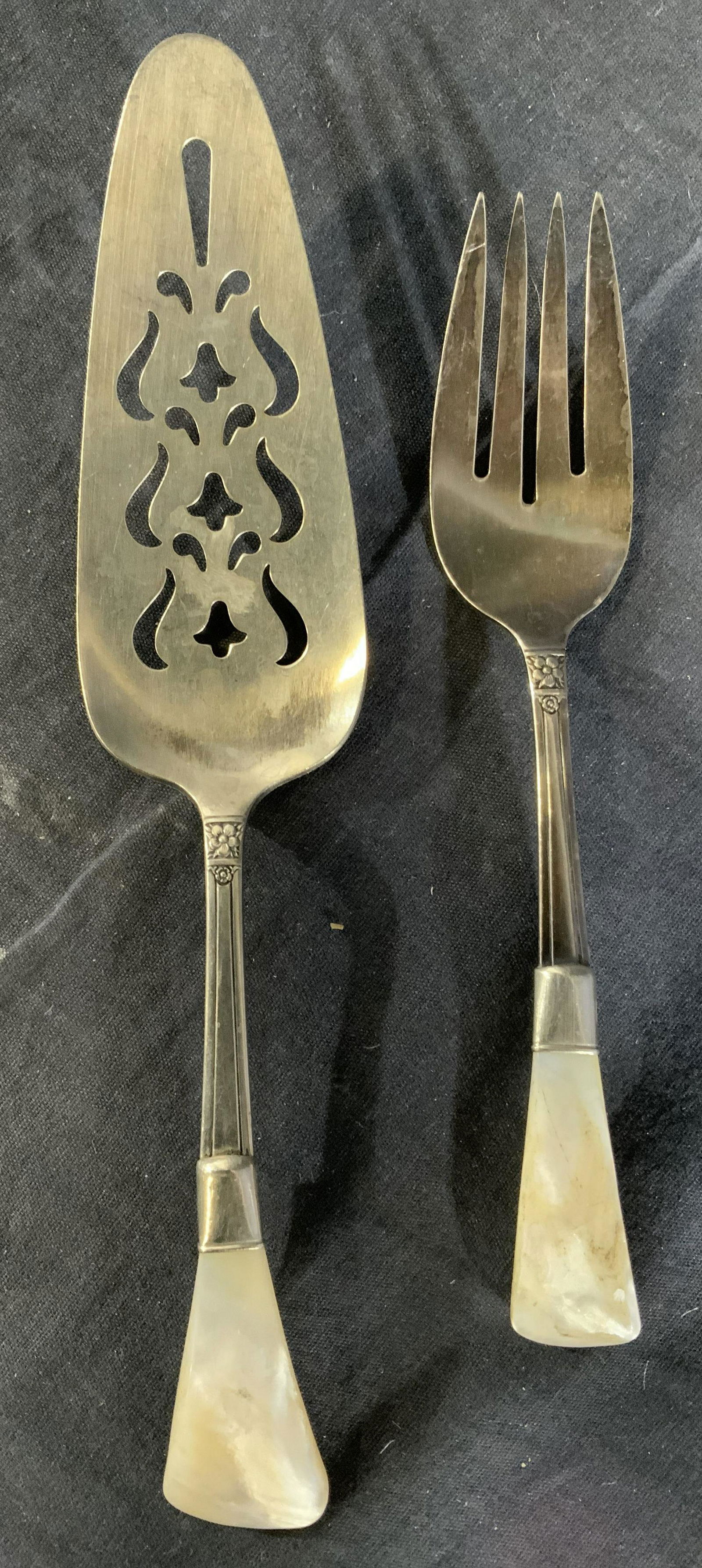 NATIONAL SILVER CO Cake Server & Salad Serve Fork: Lot includes 1 salad serving fork & 1 cake serving utensil. Each piece is inscribed NATIONAL SILVER CO & has mother of Pearl handles. Cake server has pierced detail. Largest utensil measures approx 9.