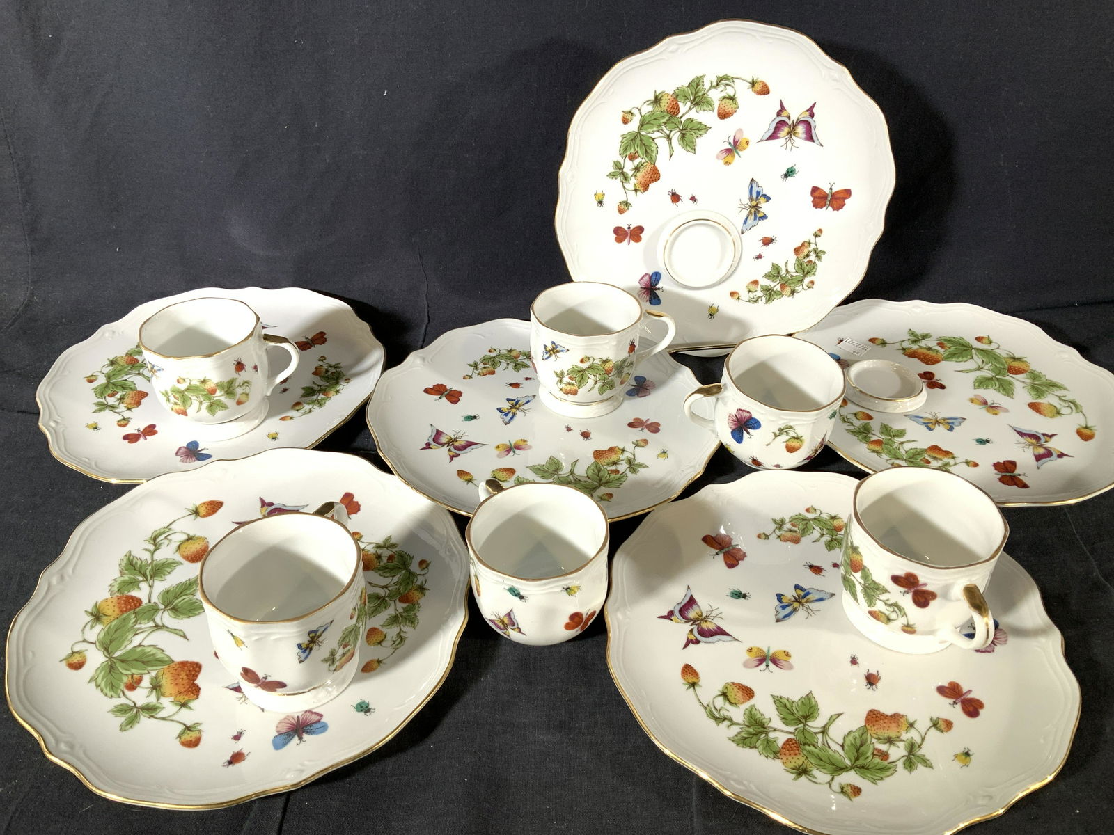 Fine Bone Chinaware Set 12 Cup & Plates: White porcelain with hand painted butterflies, in the style of Herends Queen Victoria. Gilt rims. 6 plates, each plate with an tea cup holder , 6 tea cups. No marks on plates, tea cups are stamped 617