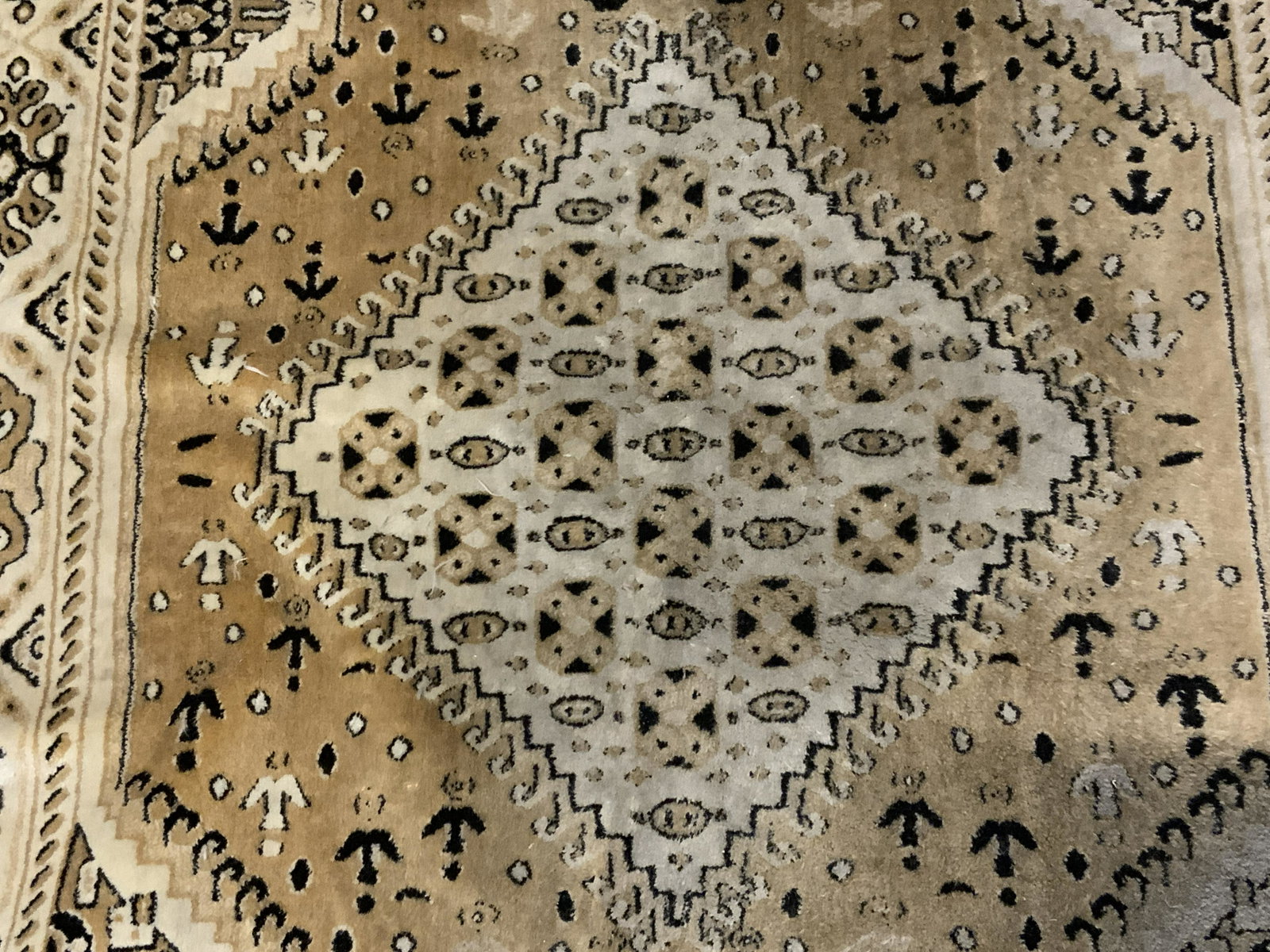 Fringed Area Rug: Fringed area rug, possibly vintage. Decorated with multi toned medallion, floral, and geometric patterns. Wear is consistent with age and use. Measures approx 42 inches long, 28 inches w. Carpets, rug