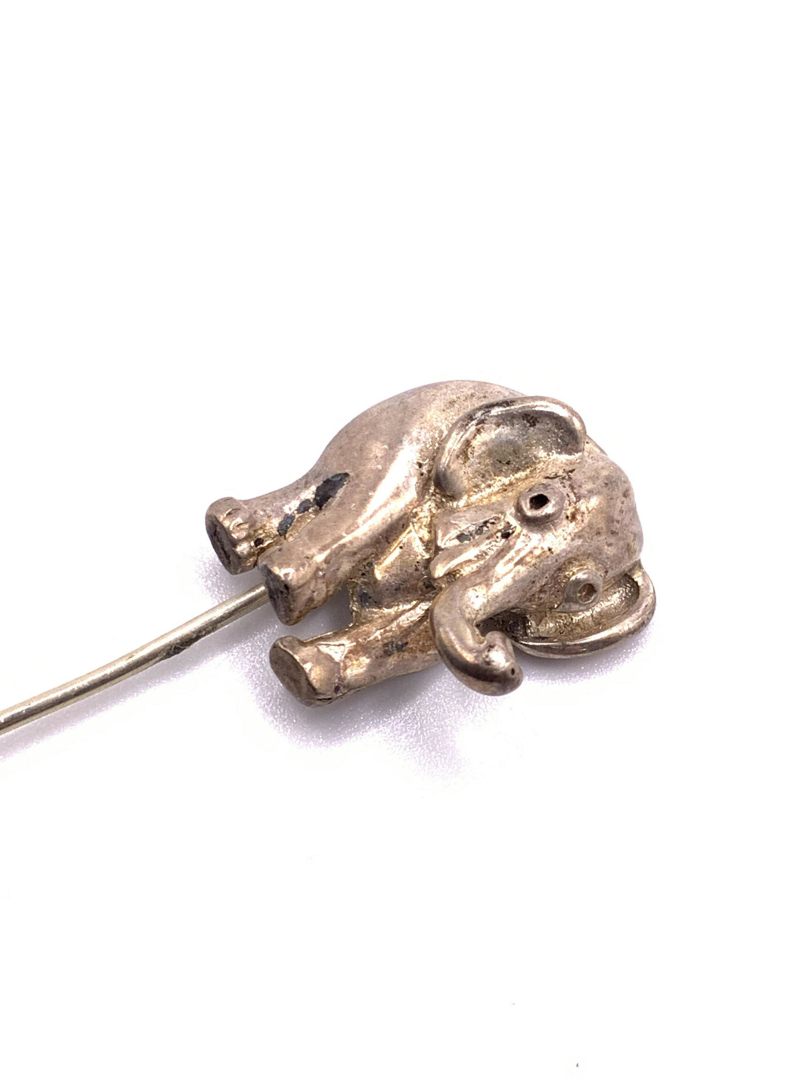 STERLING SILVER Vintage Elephant Form Pin, Jewelry: A vintage sterling silver elephant form sweater pin / brooch. Reverse marked Sterling. Measures approx 2.5L x .5W in. Total weight .12 ozt. Some surface wear consistent with use and age. Collectible j