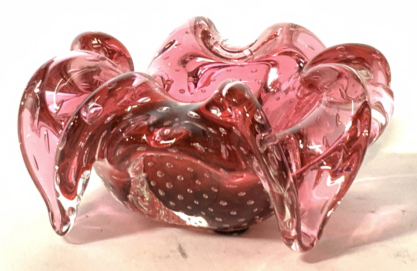 Vintage Floral Cranberry Glass Vessel: A vintage cranberry glass vessel in the shape of a flower with drooping petals. Approximately 3 in tall and 5.5 in wide. Good condition. Cranberry glass, vintage cranberry glass, glass, decorative gla
