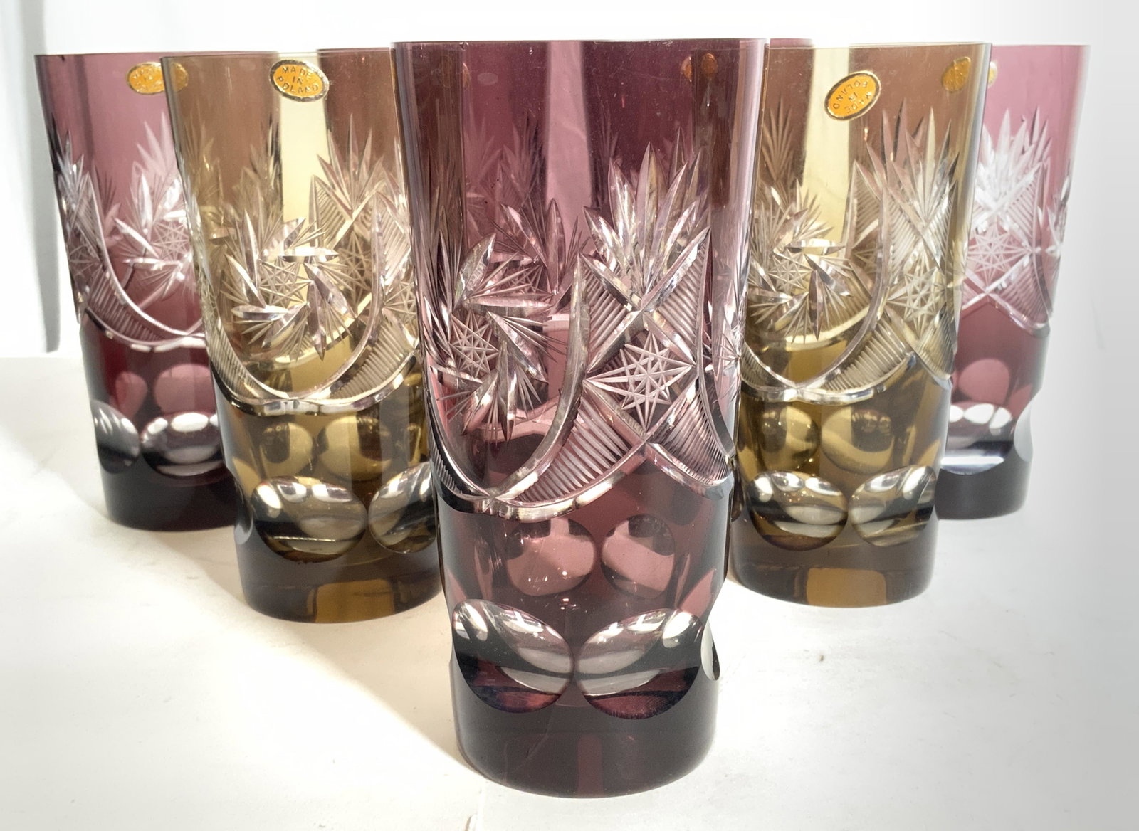 Lot 7 Polish Bohemian Glass Vessels: Lot includes 7 vessels. Each have tags which read MADE IN POLAND. Lot includes 5 purple & 2 gold toned vessels. Each vessel measures approx 6 inches tall 3 inches wide. Vessels, Art glass, Art glass v