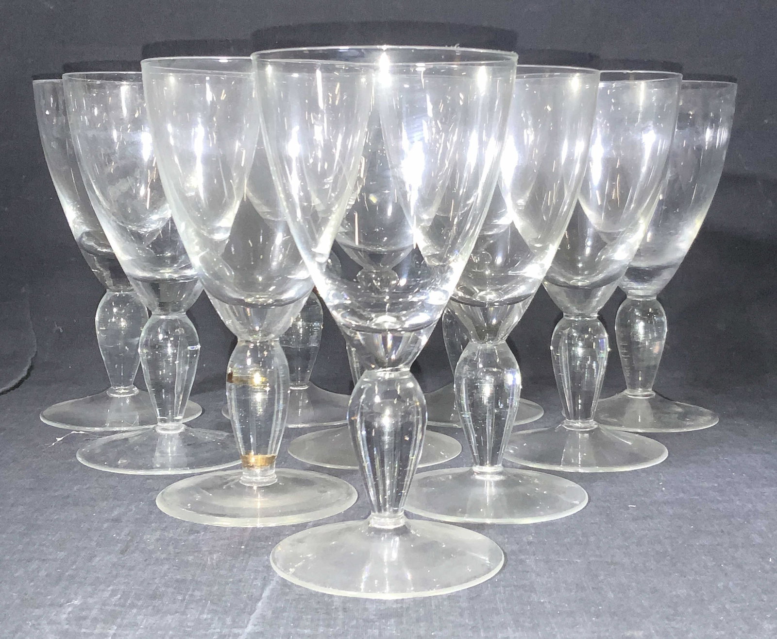 10 Crystal Wine Glasses: A set of 10 crystal made wine glasses with rounded solid stems and minimalist cups. Approximately 6.75 in tall and 3.5 inches in diameter. Property of Manhattan, New York Estate of D. Winston, matchma