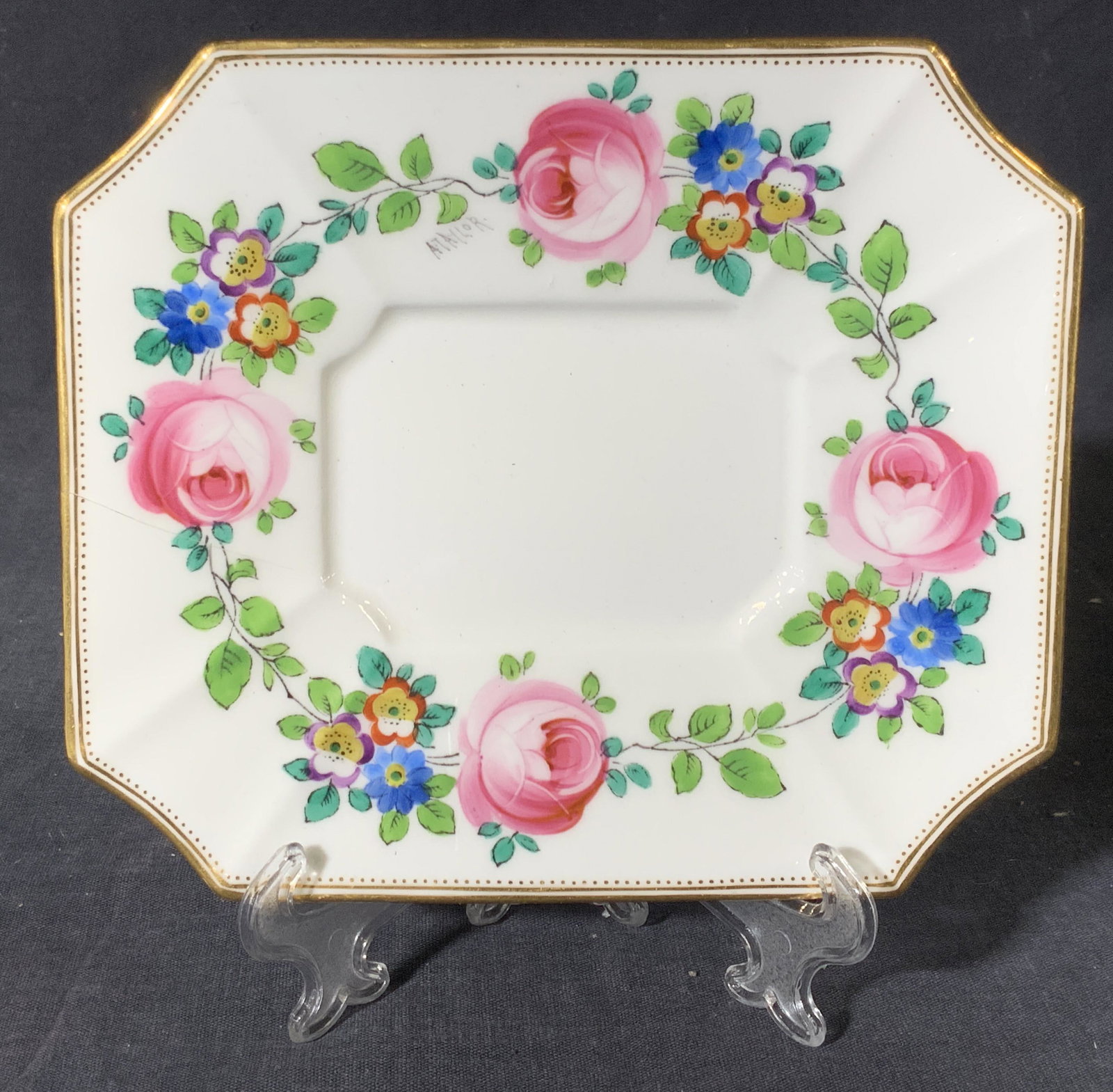MINTONS Octagonal Porcelain Trinket Dish: Porcelain dish marked Minton on underside. An octagonal dish with a gold gilt rim and accent dots near rim, while in the center is hand painted motifs of roses and other flowers of pink, blue, red and