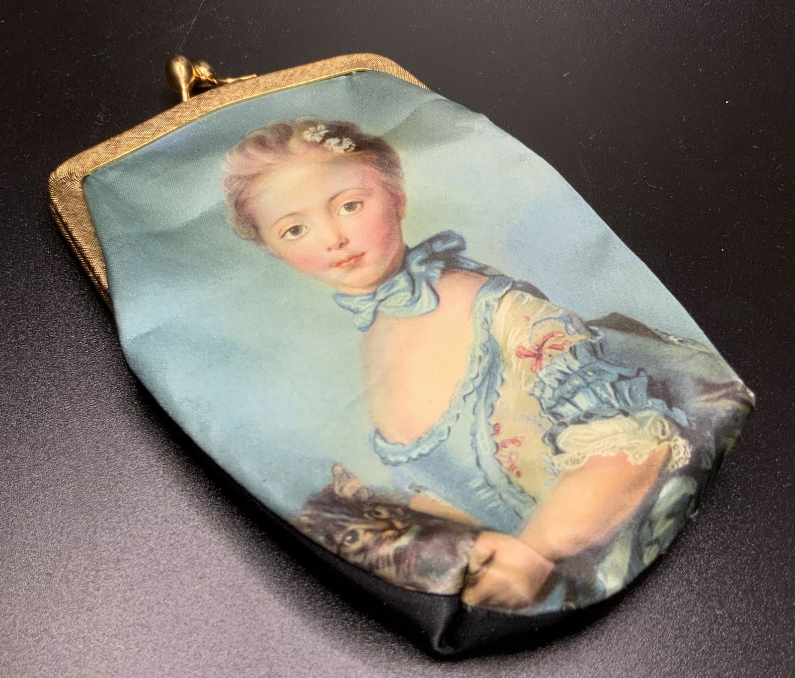 GARBO MILANO Vintage Italian Satin Coin Purse: A vintage satin coin purse depicting a Renaissance style girl with her cat on the obverse, reverse is black. Gold tone metal snap closure. The interior is lined with red fabric. Interior tag reads GAR