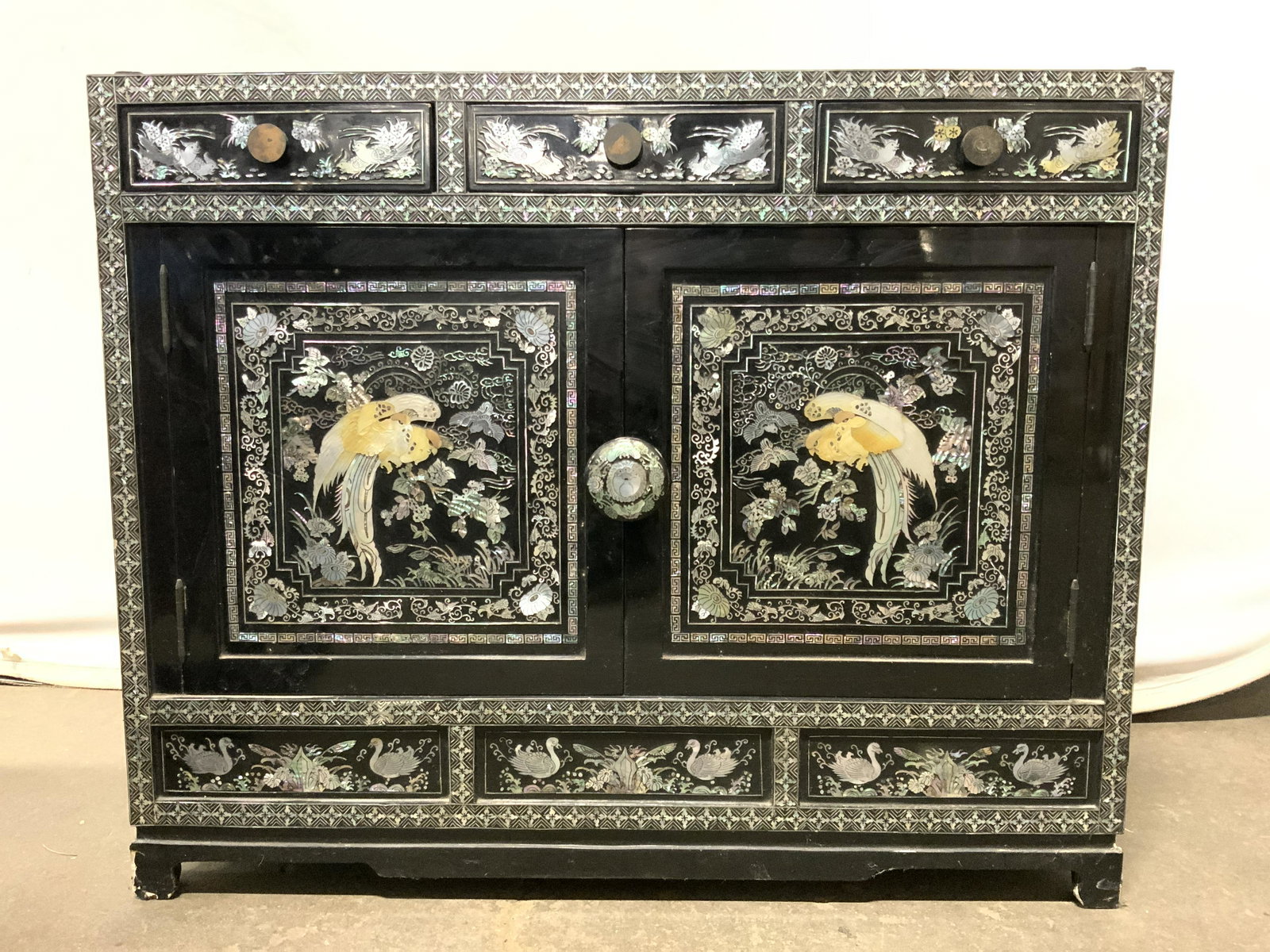 Vntg Asian Lacquered Chest W Mother Of Pearl: Chest is vintage. Piece has intricate multi toned mother of Pearl detail. Piece has 3 drawers near top with knob shaped handles & cabinet door area. Piece measures approx 25 inches tall 30 inches long
