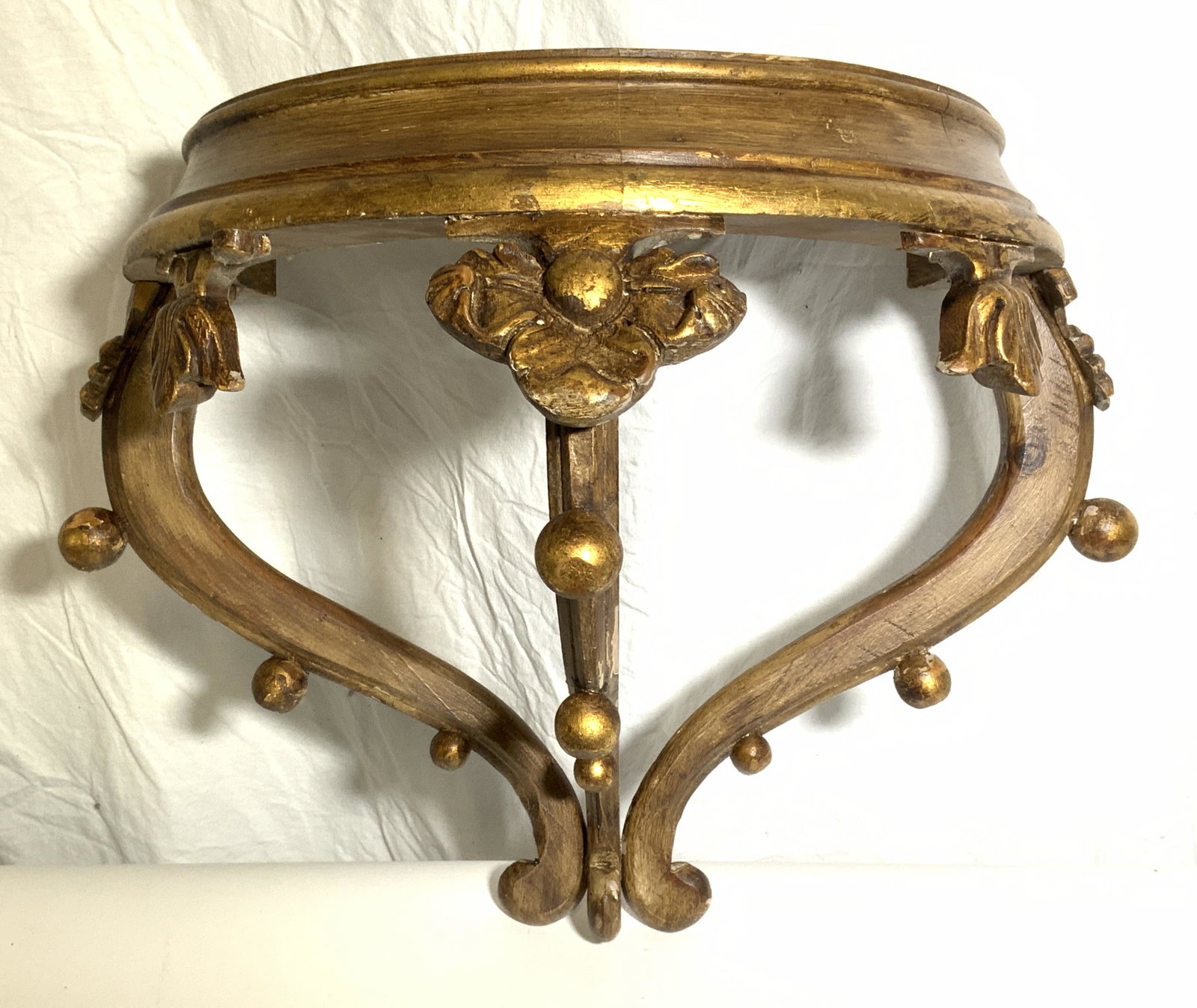 Vintage Gold Leaf Wooden Canopy Hanger: Piece is gold leafed and wooden. Backside has 2 areas to hand piece from. Piece has carved floral detail in addition to spherical shapes. Top of piece has half circle shape. Piece measures approx 16 i