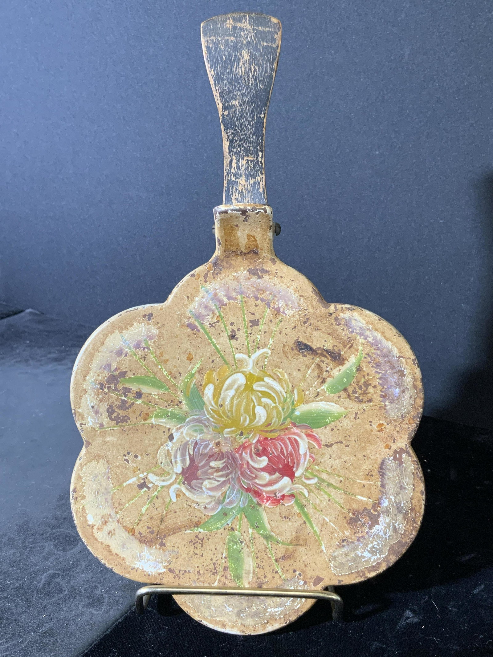 Antique Toleware Silent Butler: Antique Toleware silent butler. Decorated with hand painted floral patterns. Handle is wooden. Label on underside is worn. Wear is consistent with age and use, rusting present, wear to paints. Measure
