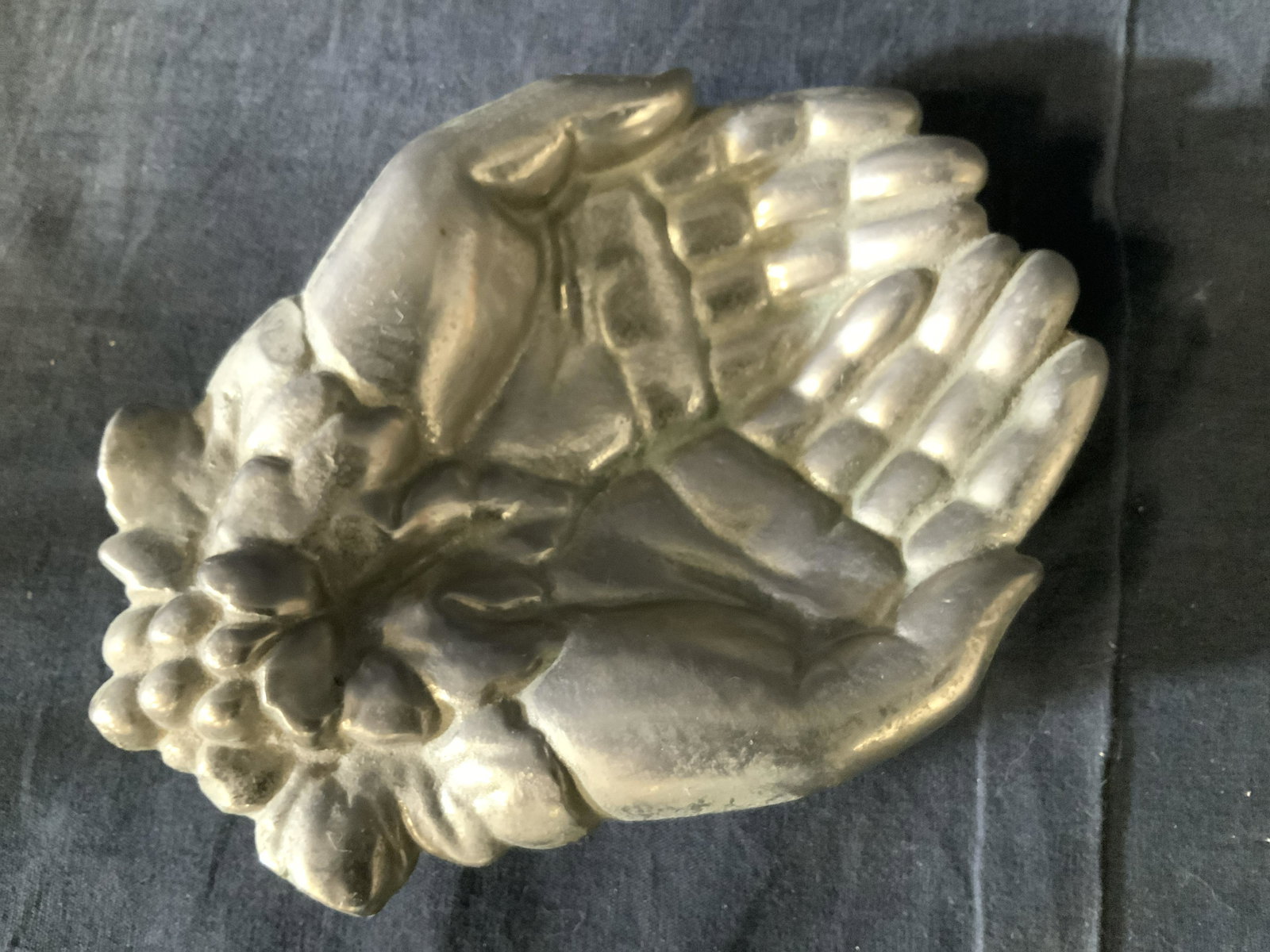 Metal Prayer Hands Trinket Dish: Signed H.O. On verso is this cast white metal hands cupped together with grape leaf at wrists. Weighted piece, measures 7 x 5.5 x 1 in. Up cycle for modem use. Vanity accessory, business card holder, 
