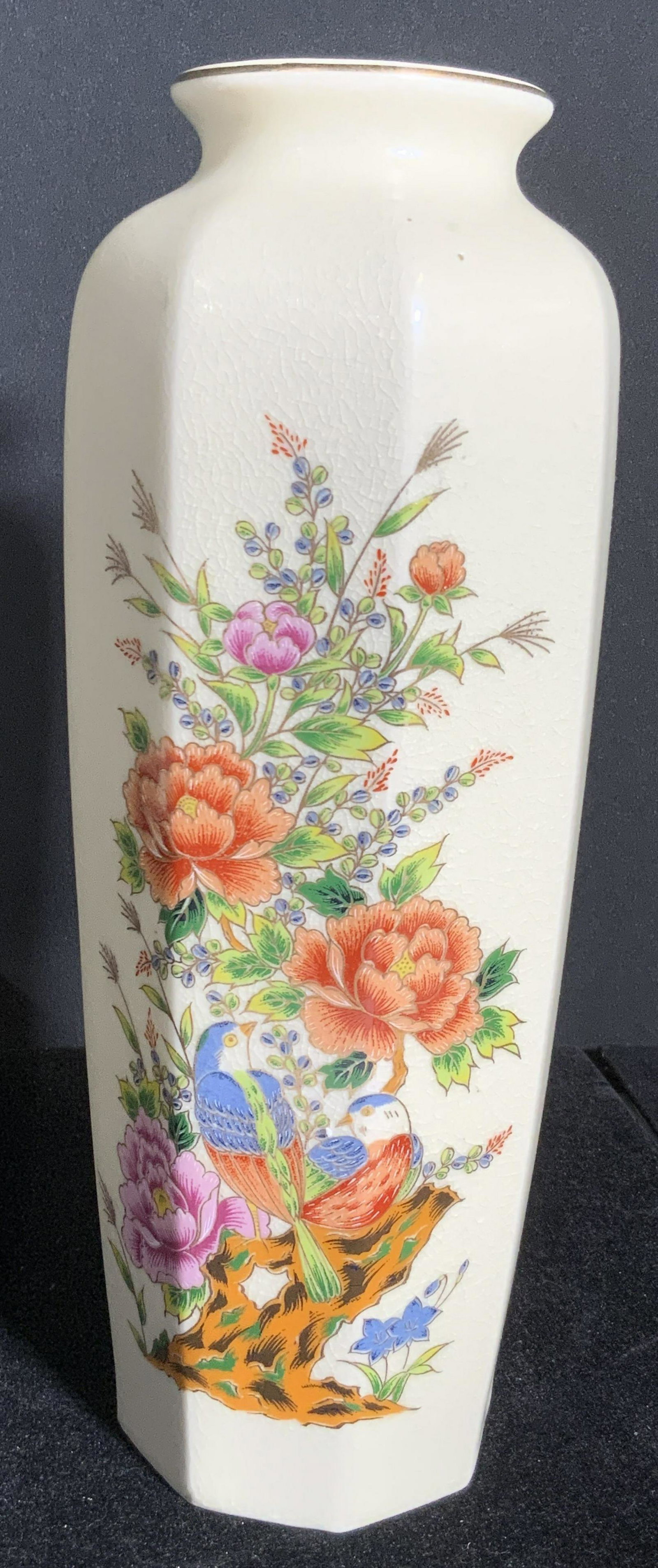 Vintage Signed Asian Floral Porcelain Vase: A vintage hand painted floral Asian porcelain vase. Gilt line work throughout. The designs feature colorful florals and birds. Ribbed design. Underside is signed with red Asian characters. Underside r