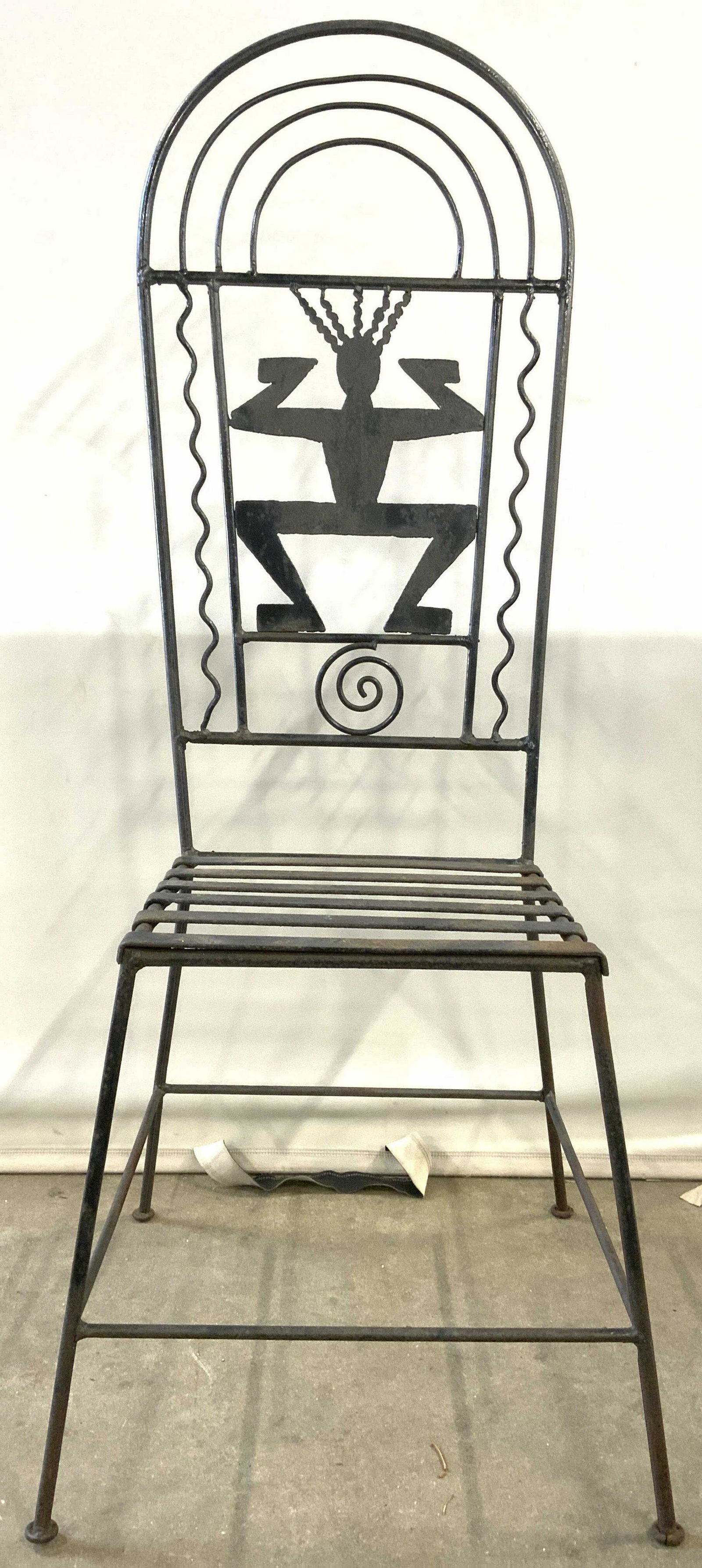 Vintage Iron Chair W Figural Structure: Chair is vintage and metal, piece appears to be iron. Backrest has Keith Haring style figure is center of backrest. Chair has 4 legs with box stretcher in between. Top of backrest has arched shape. Lo