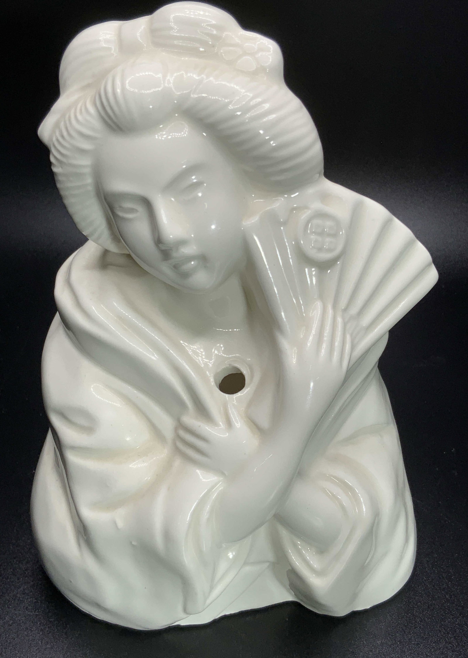 ORCHIDS OF HAWAII Sign Porcelain Geisha Figural: A white glazed porcelain vase / Vessel crafted to resemble a Geisha. Signed ORCHIDS OF HAWAII, Taiwan on underside. Measures approx 6H x 4.5W in. Drilled hole to obverse, open back. Some pitting and d