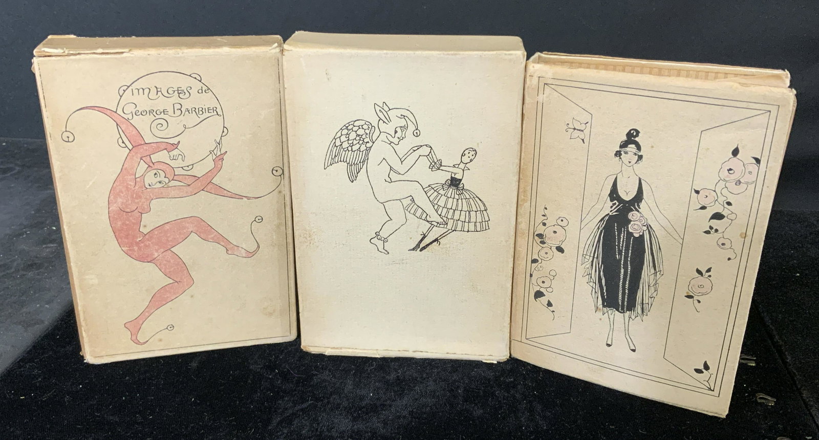 Lot 3 Antique Volumes LA GUIRLANDE DES MOISE: 3 antique copies of La GUIRLANDE Des MOISE, by George Barbier. Paper dust jackets over silk bindings, two volumes include board sleeves. Copies of 1917, 1918, and 1920 volumes. Wear is consistent with