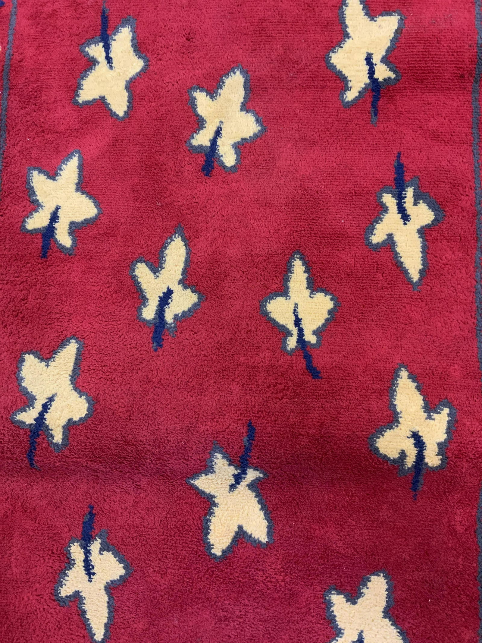 Red Toned Area Rug: Decorated with leaf like patterns, bordered by Diamond shaped patterns. Wear is consistent with age and use, ends curling. Measures approx 37.5 inches long, 27.5 inches w. Property of a Manhattan New
