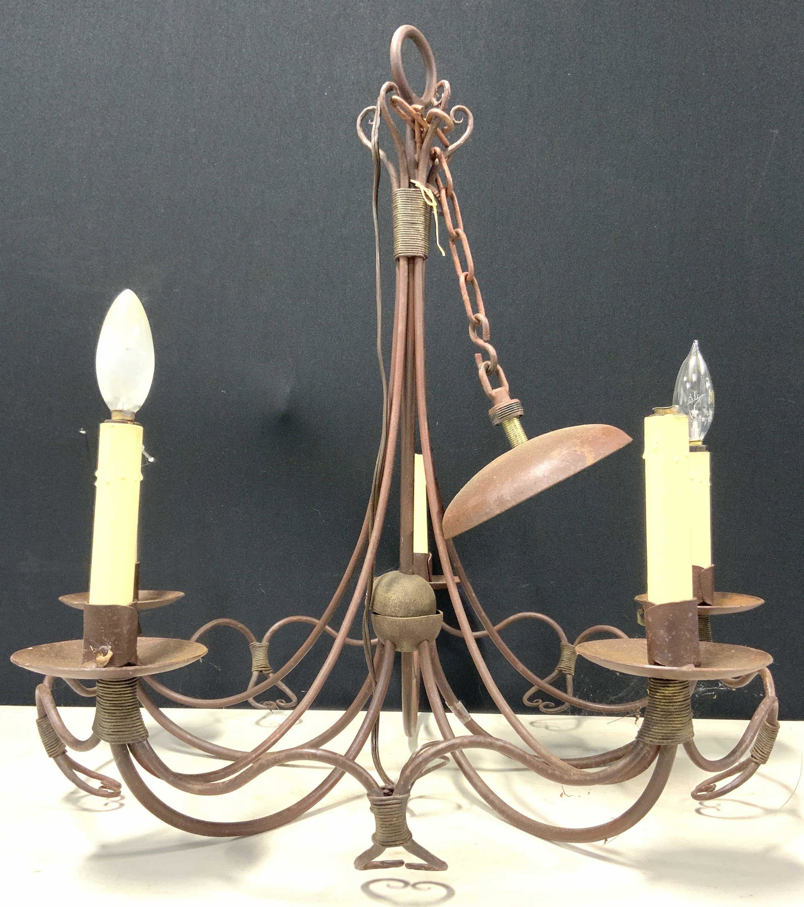 Vintage Metal 5 Arm Chandelier: Chandelier is vintage possibly antique. Piece contains 5 arms, each with candlestick style bulb sockets at ends. Chandelier measures approx 31 inches tall 22 inches wide. Chandelier, vintage chandelie