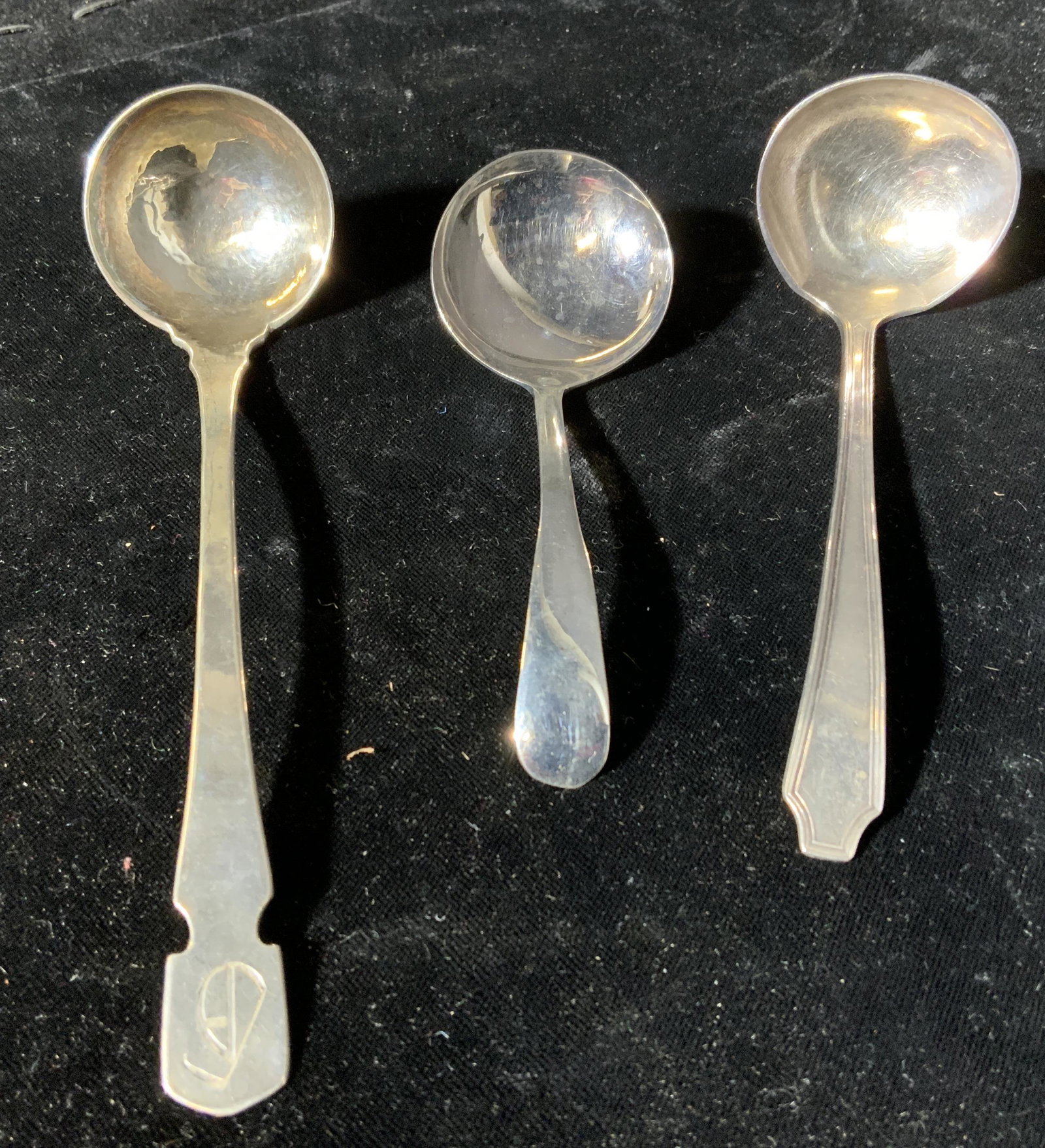 Lot 3 Spoons, Sterling & Silver Plated: Lot 3 silver spoons. 1 marked sterling, two are silver plated. Undersides read as 1847 Rogers Brother IS, Silver Plated Made In England, and Sterling Kalo. Surface wear and scratches present. Sterling