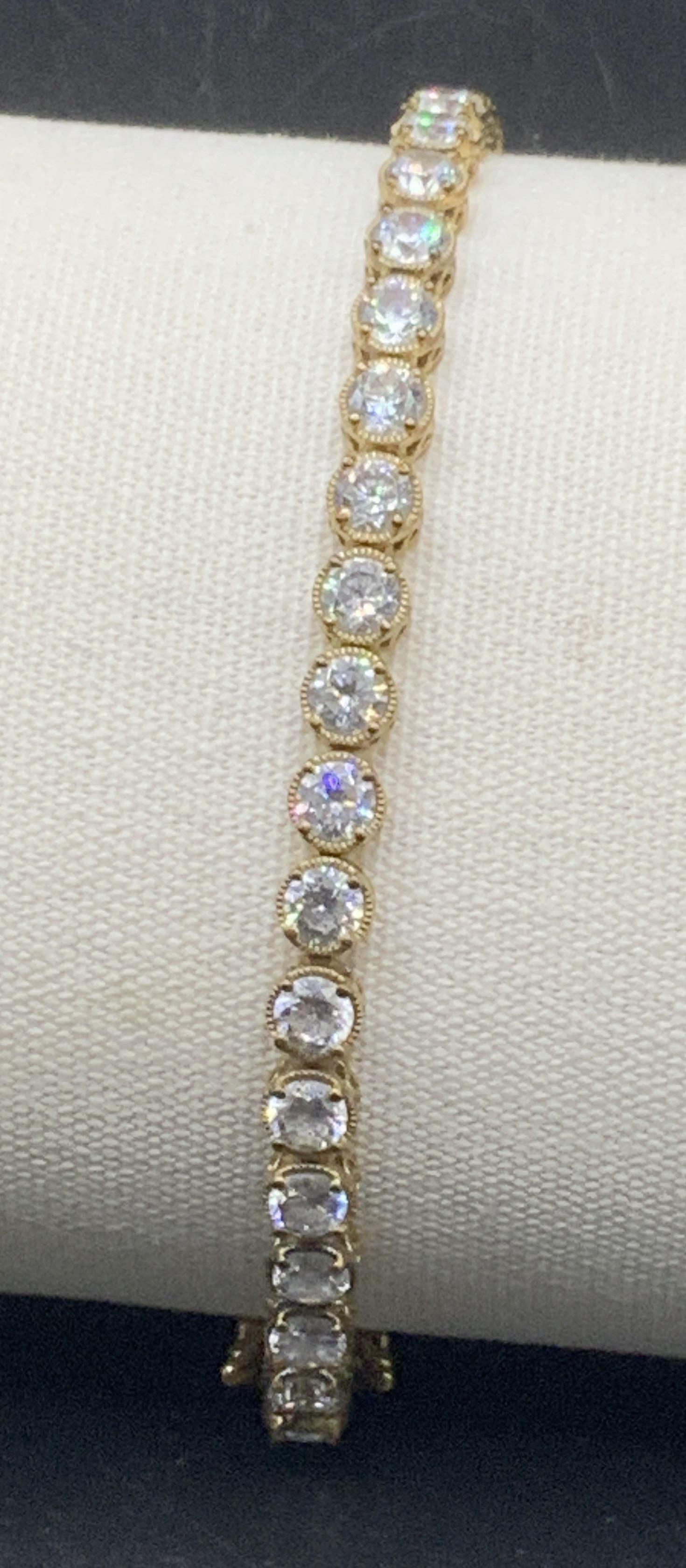 Vermeil over Sterling CZ Tennis Bracelet: Vintage Tennis Bracelet with prong set round CZ stones , app 3.5-4 mm, box clasp, hallmarked CZ925. 8 in. Long. .47 ozt total weight Tennis bracelet, Vermeil over sterling silver Bracelet, Luxury CZ j