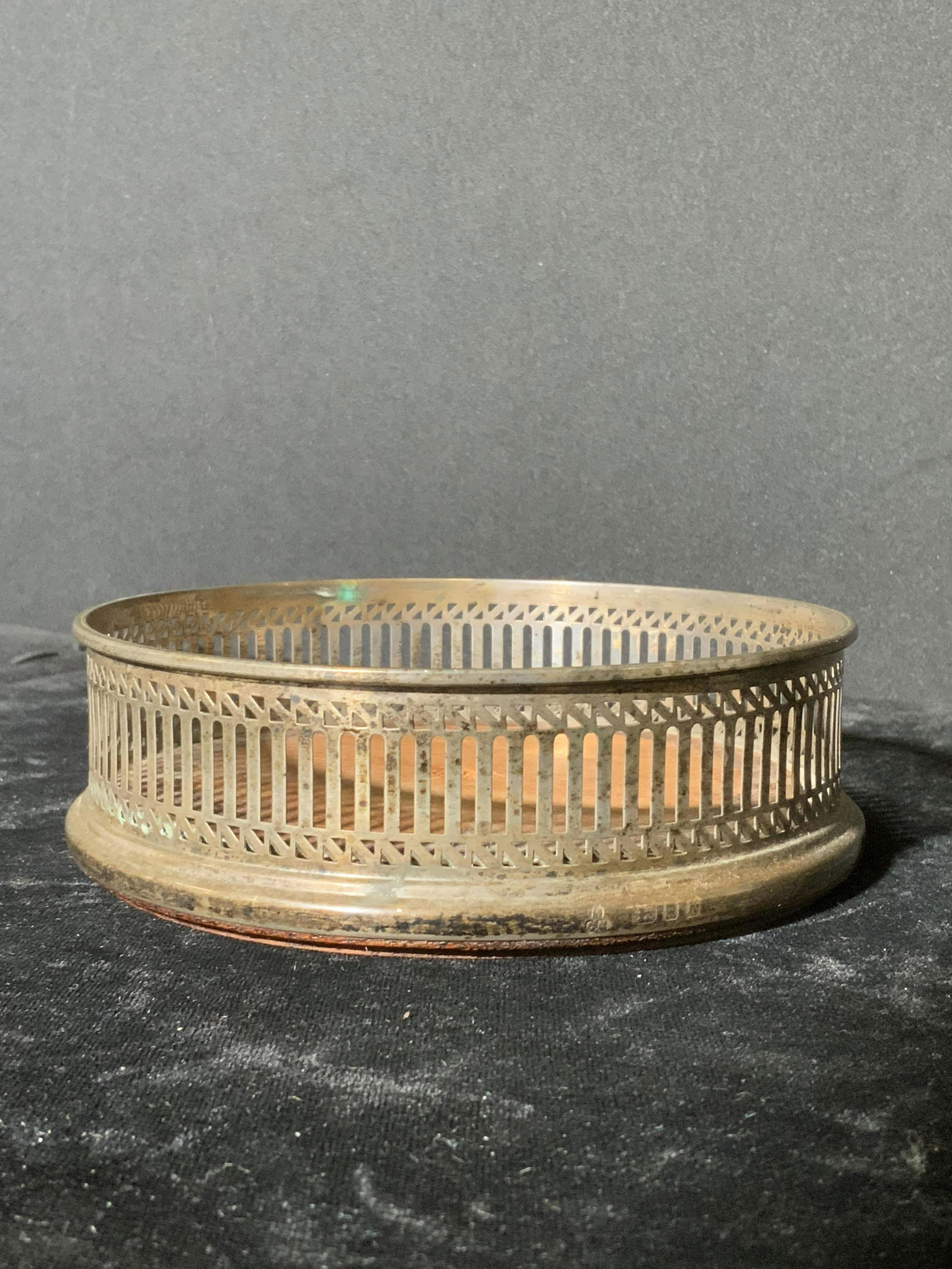 Vintage Sterling Silver Wine Coaster: Vintage sterling silver wine coaster. Tests as sterling with PuriTEST. Hall marked lions passant, leopards head, K, circa 1980â€™s English silver. Makers mark unidentifiable. Wooden center, pierc