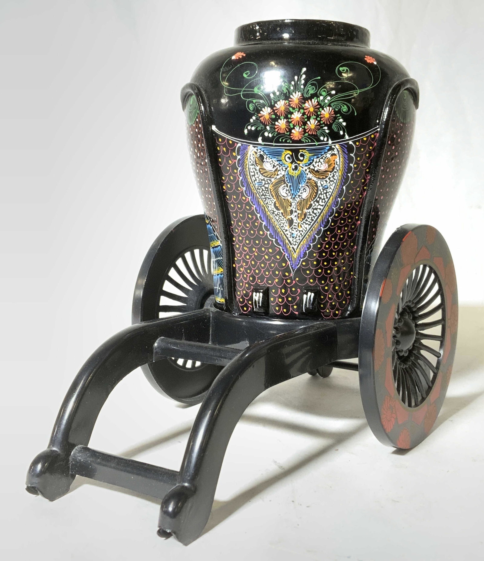 Hand painted Lacquered Wooden Urn w Base: Hand painted urn. Decorated with floral, scrolling, scale, and feather like patterns. Base resembles a rickshaw. Largest piece measures approx 3.5 inches h and 8.25 inches w. Home decor, decorative ac