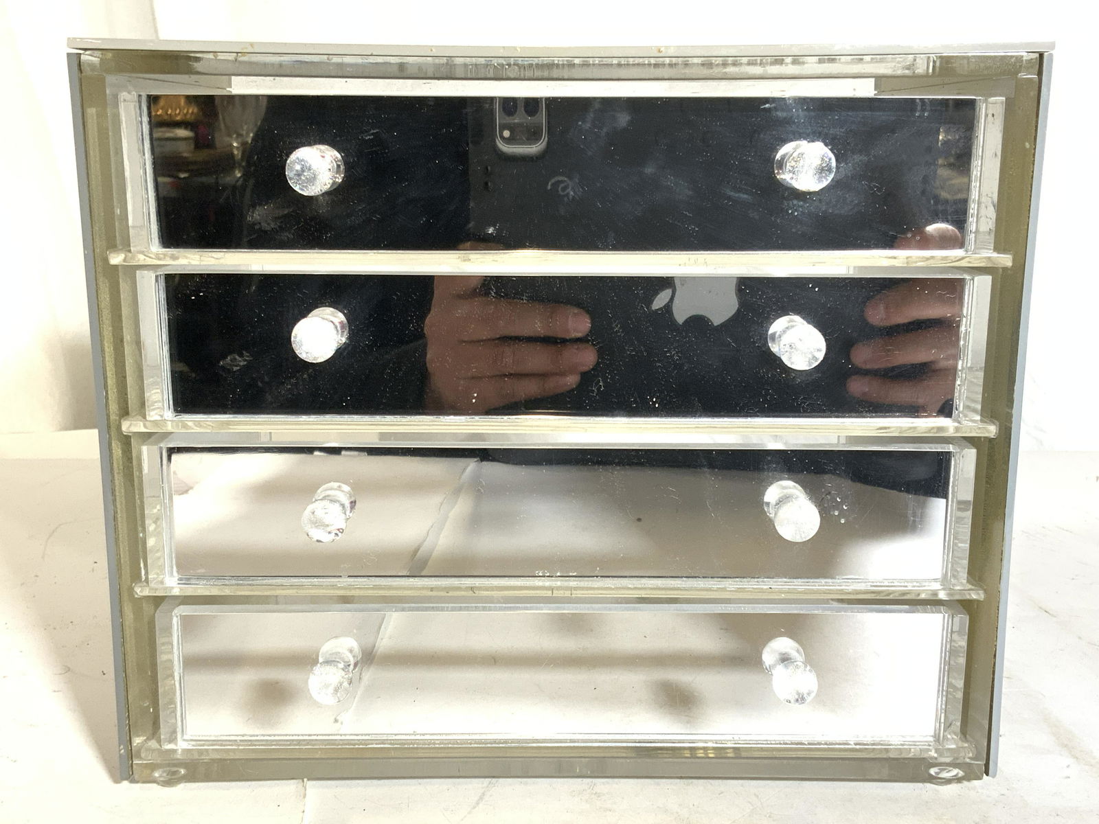 Acrylic 4 Drawer Mirrored Jewelry Box: Jewelry box has 4 drawers. Piece appears to be acrylic possibly lucite. Each drawer has spherical shaped handles. Piece has mirrored surfaces. Jewelry box measures approx 10.25 inches long 8.5 inches