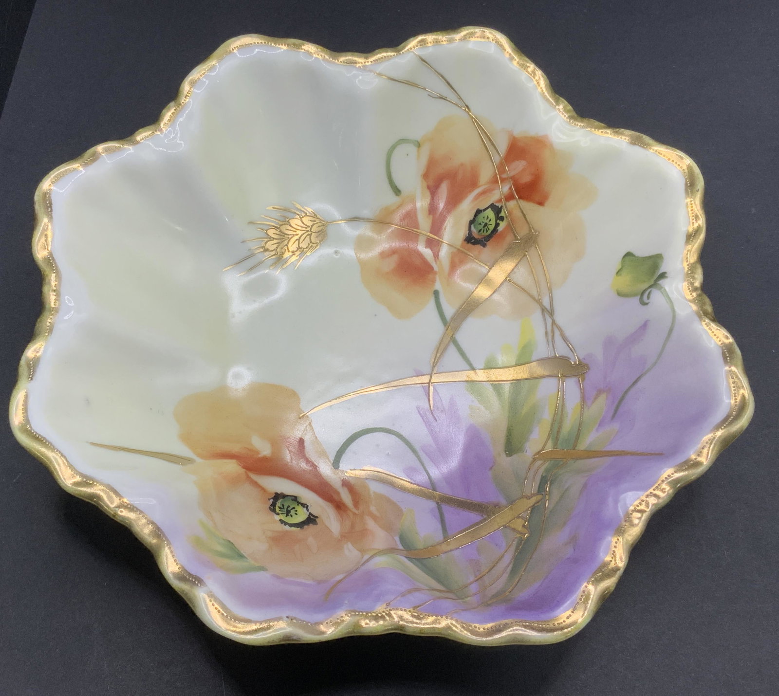 Vntg NIPPON Hand Painted Porcelain Bowl: Underside of bowl is marked NIPPON HAND PAINTED. Bowl is porcelain with scalloped sides and gilded rim. Interior has intricate hand painted multi toned floral and leaf detail. Piece measures approx 7.